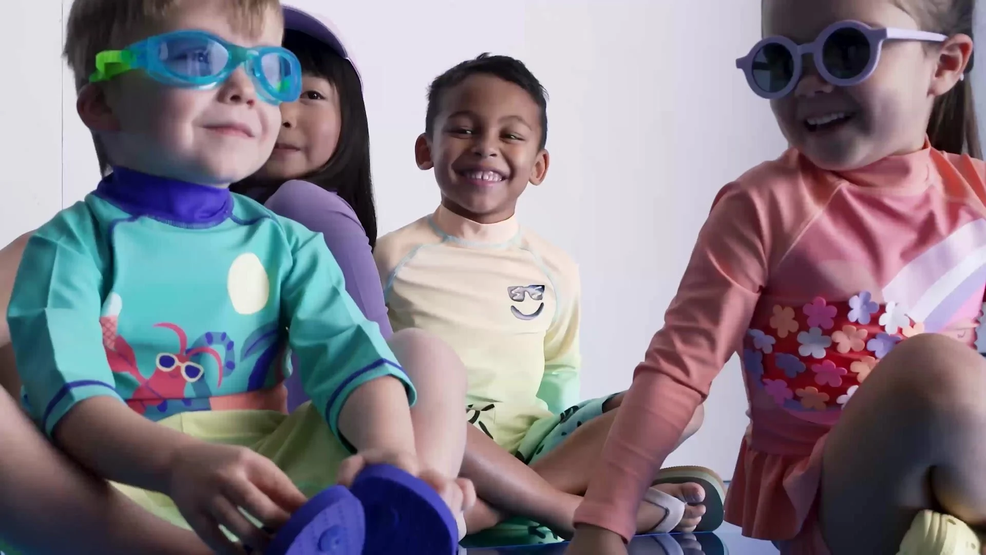 Children in Mothercare swimwear and goggles on set