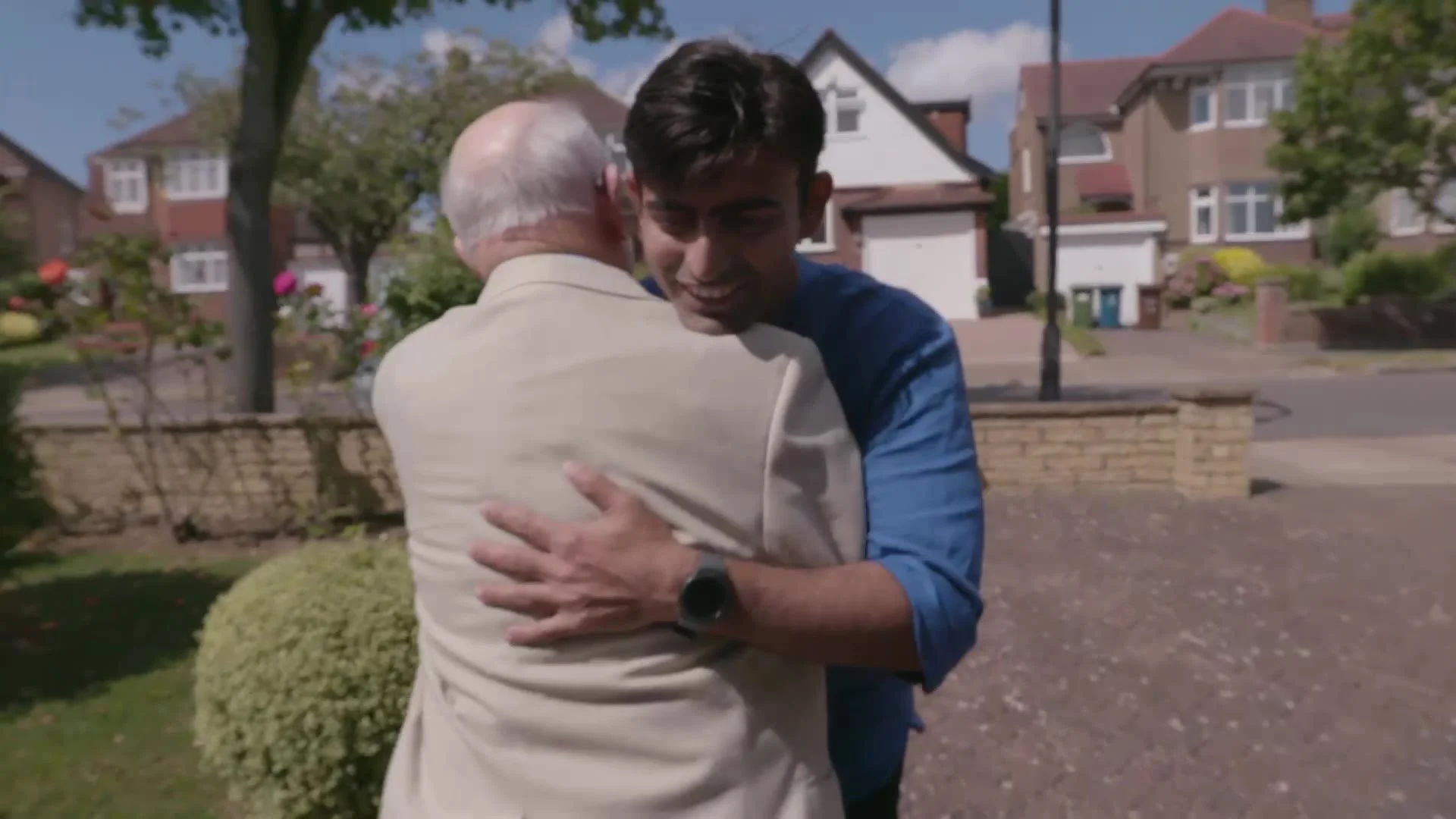 The volunteer greeting him with a hug