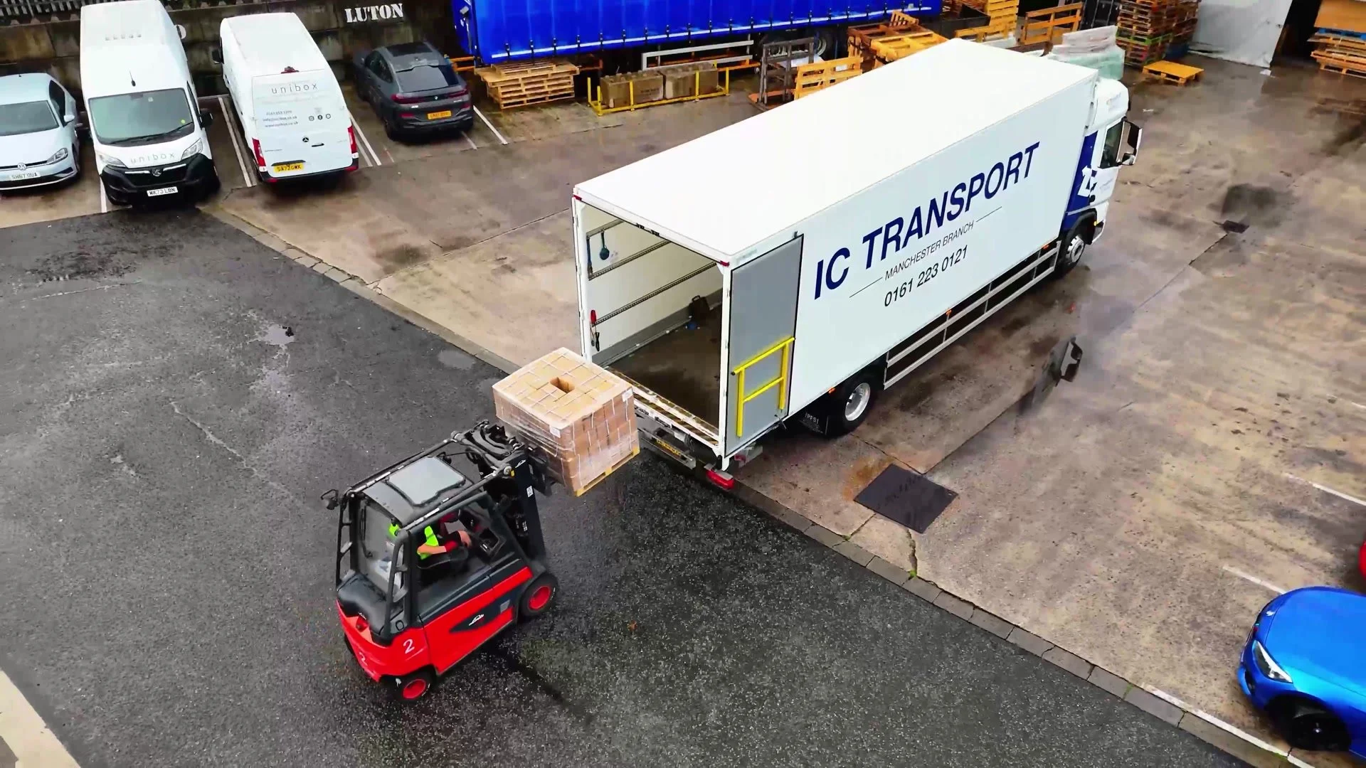 Forklift loading a lorry outside the Unibox factory