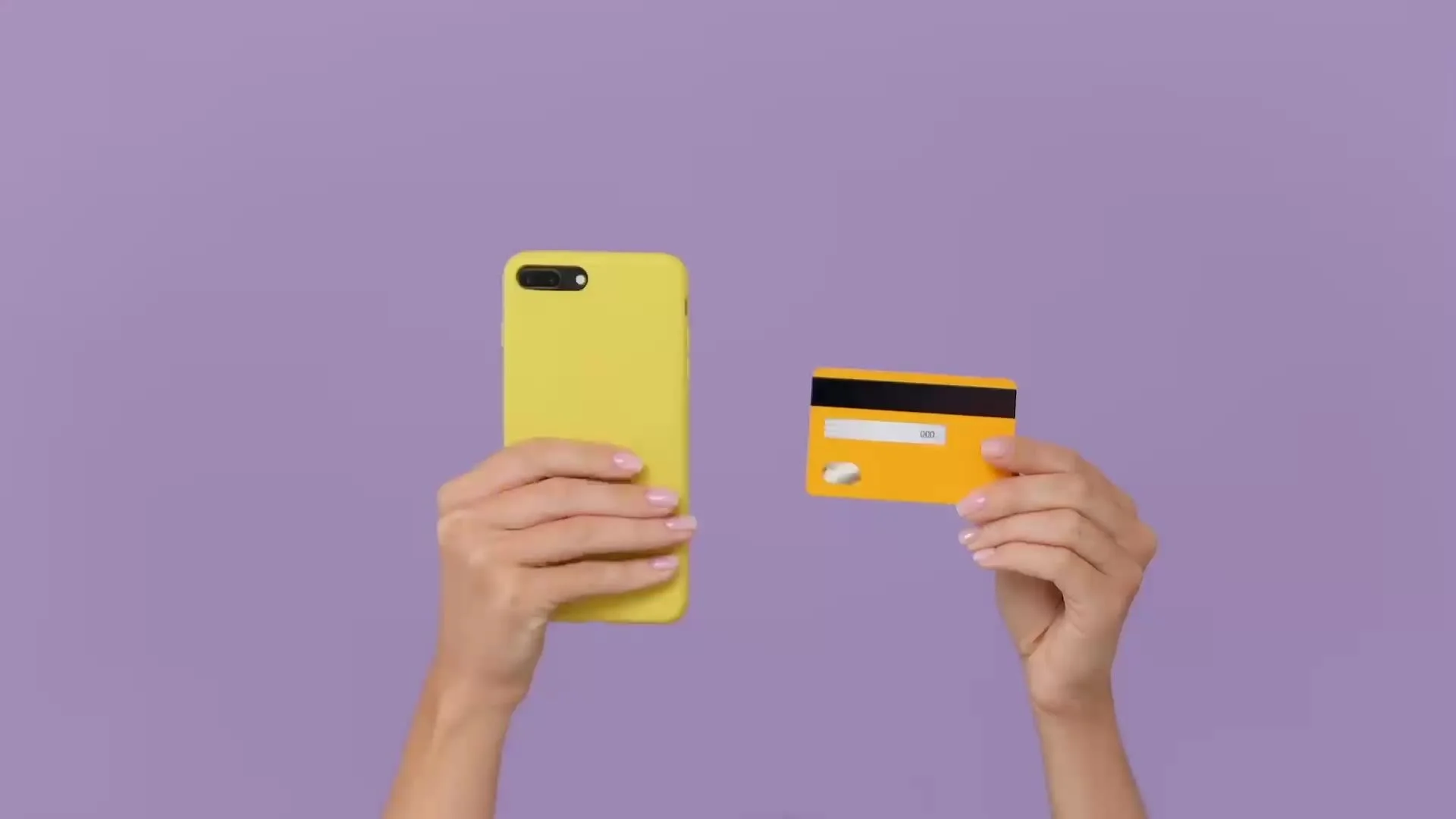 Hands holding a phone and a credit card
