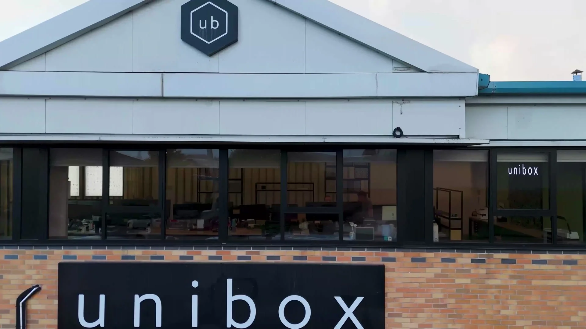 Unibox sign and logo on the front of its North Manchester headquarters