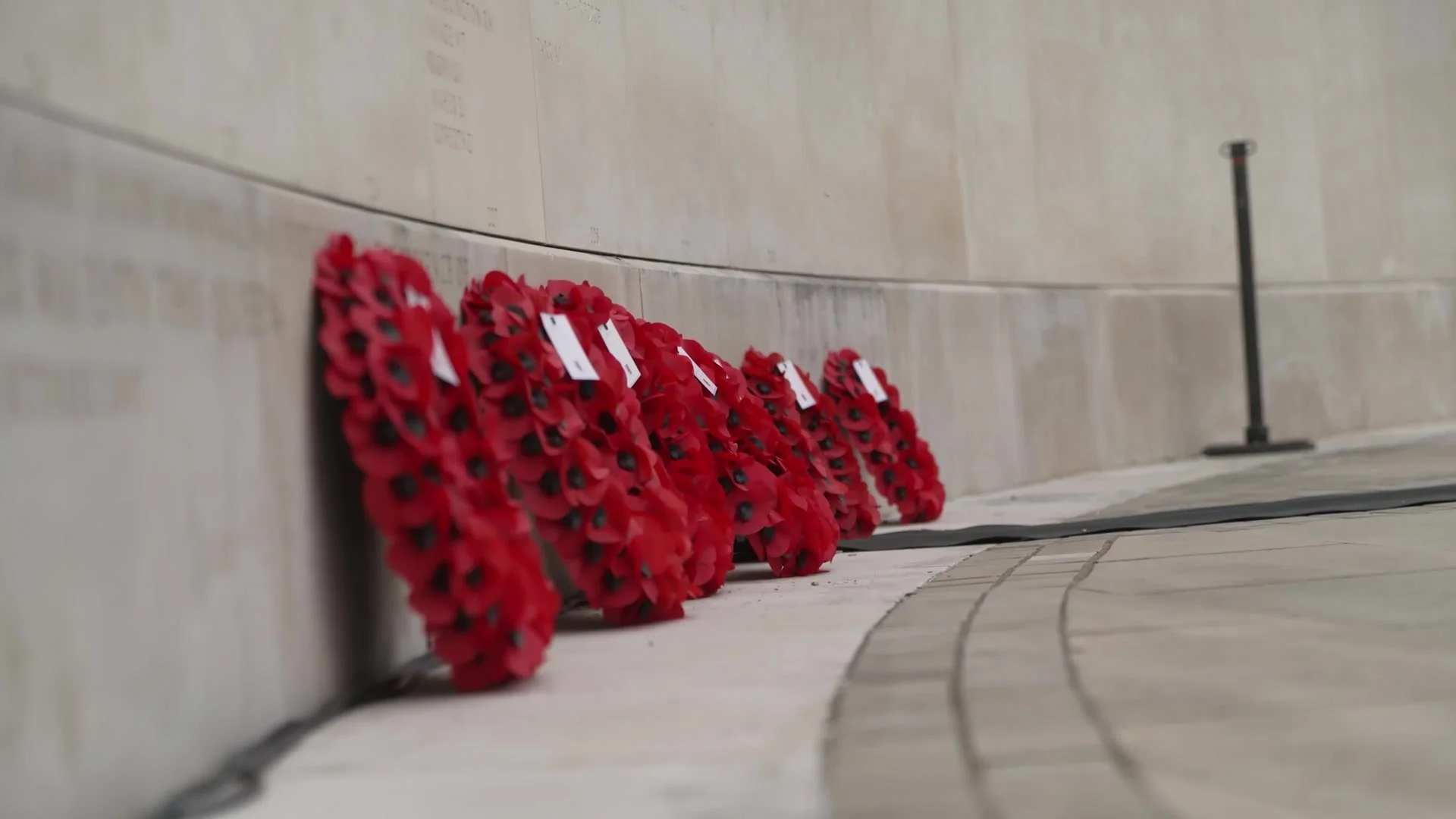 Poppy wreaths laid at the memorial wall
