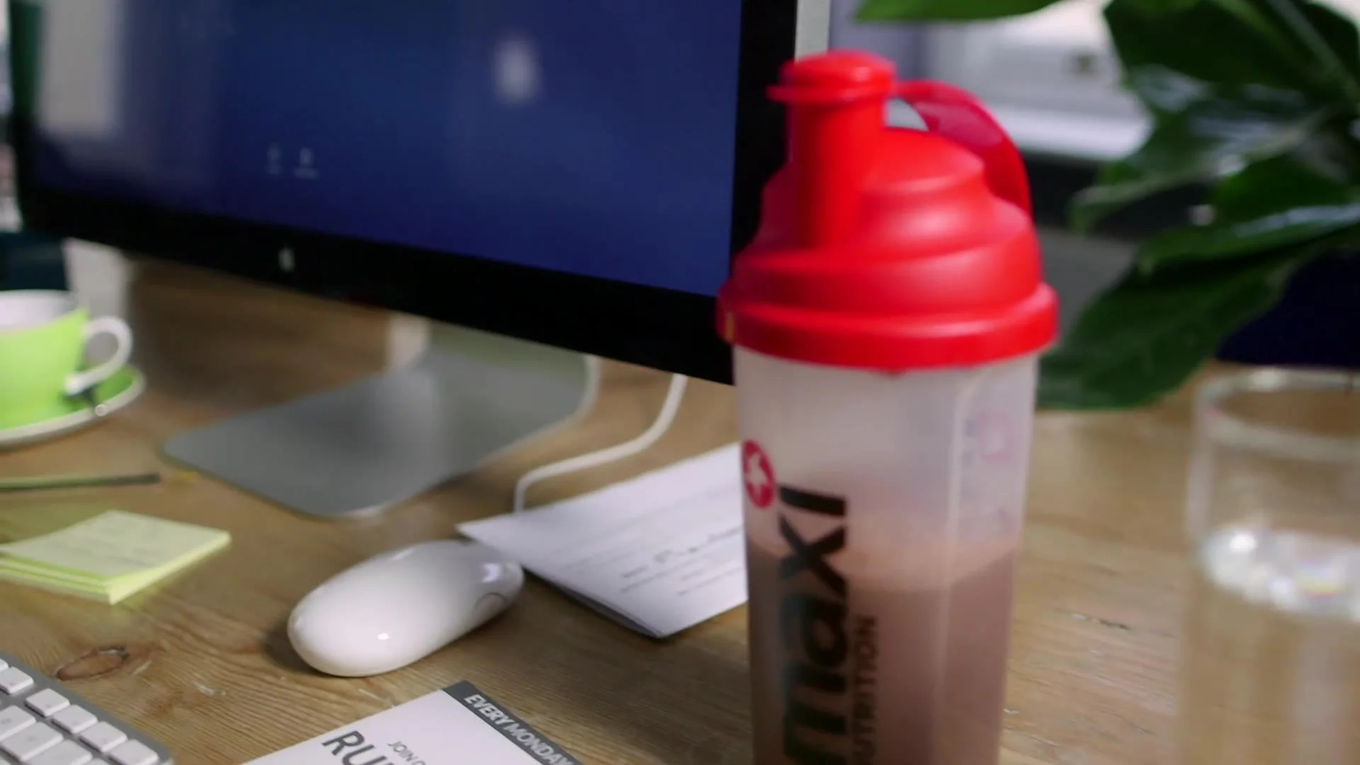 MaxiNutrition shaker on an office desk