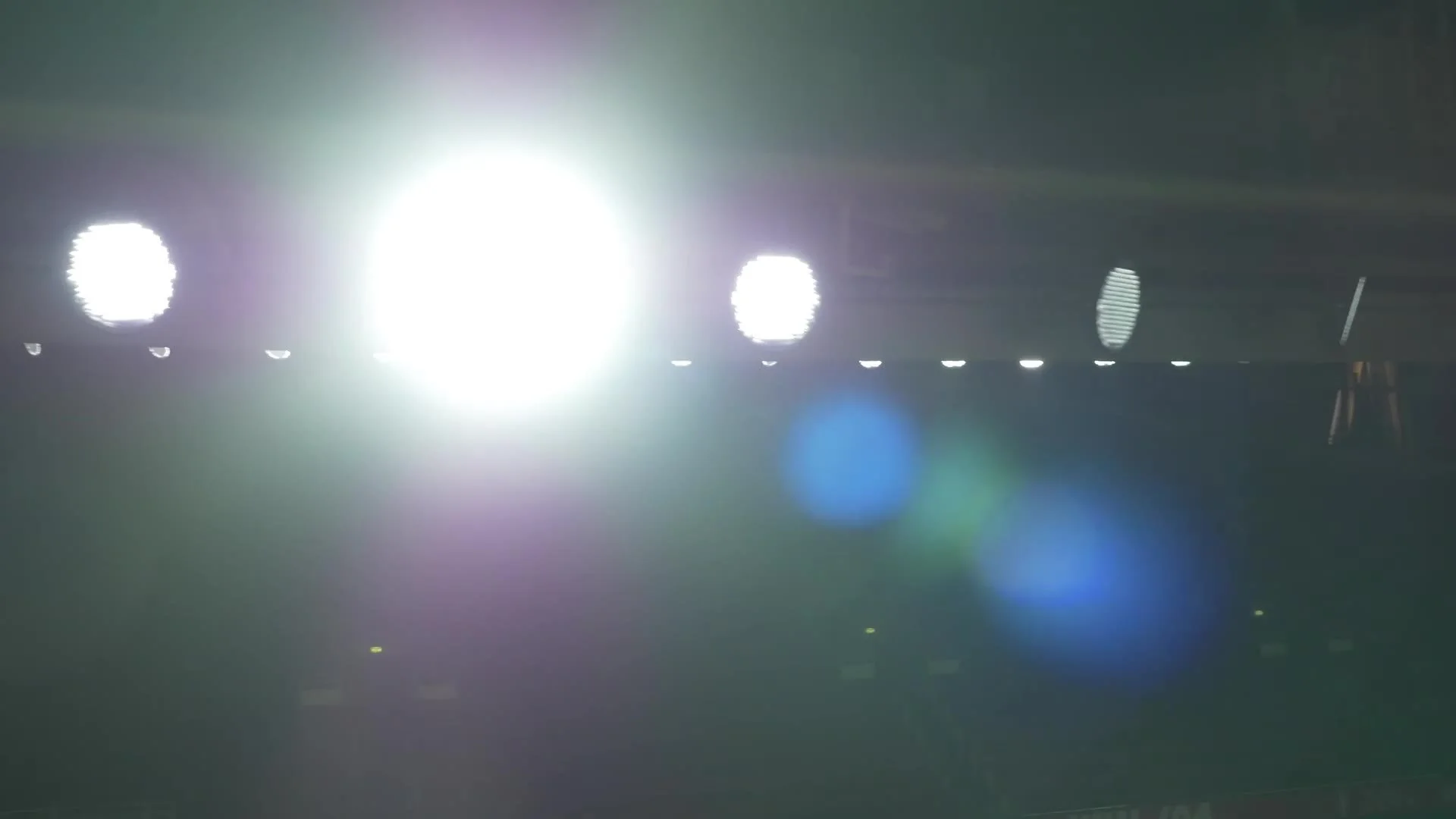 Floodlights coming back on around the stadium