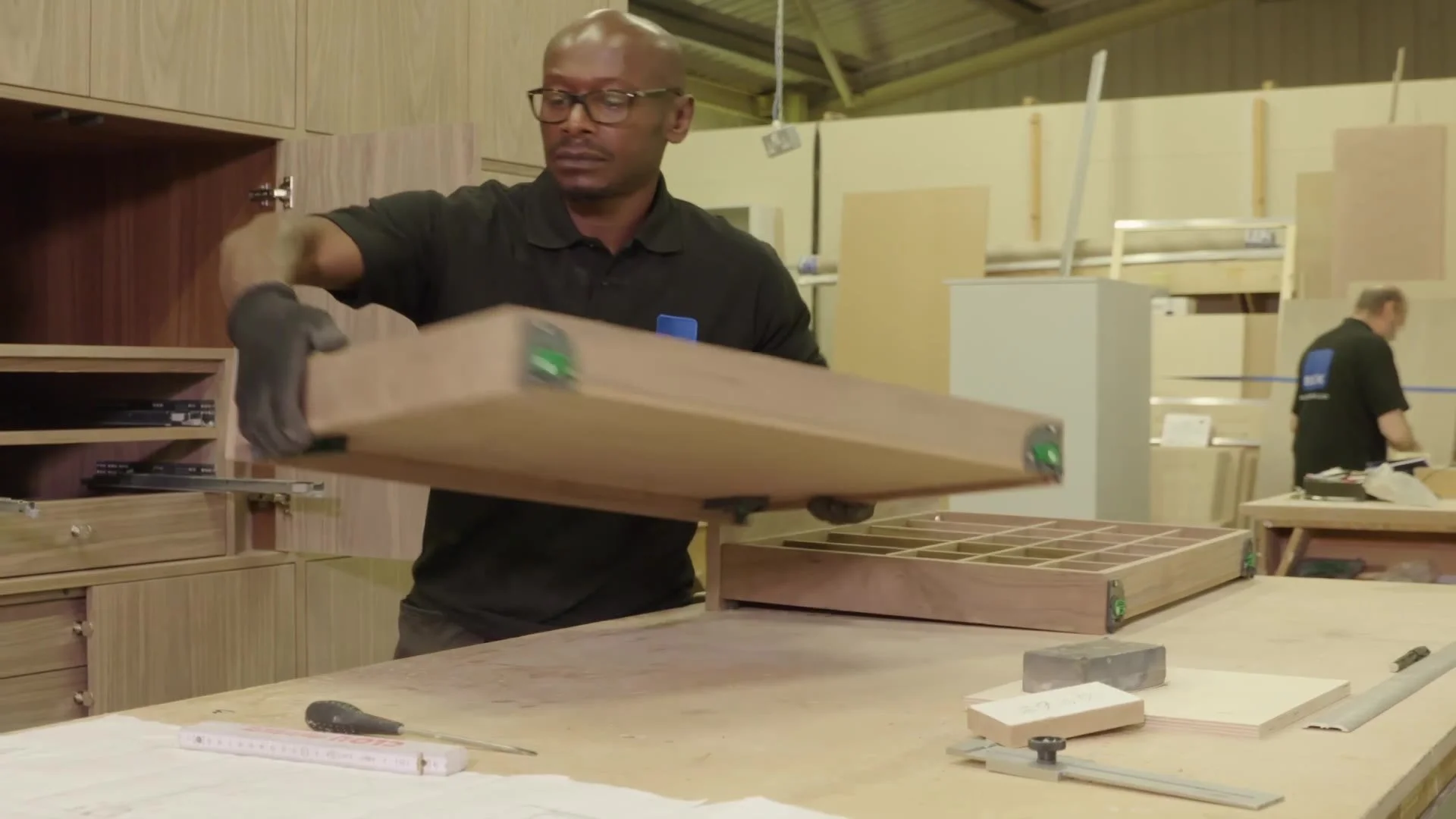 A joiner finishing a timber component