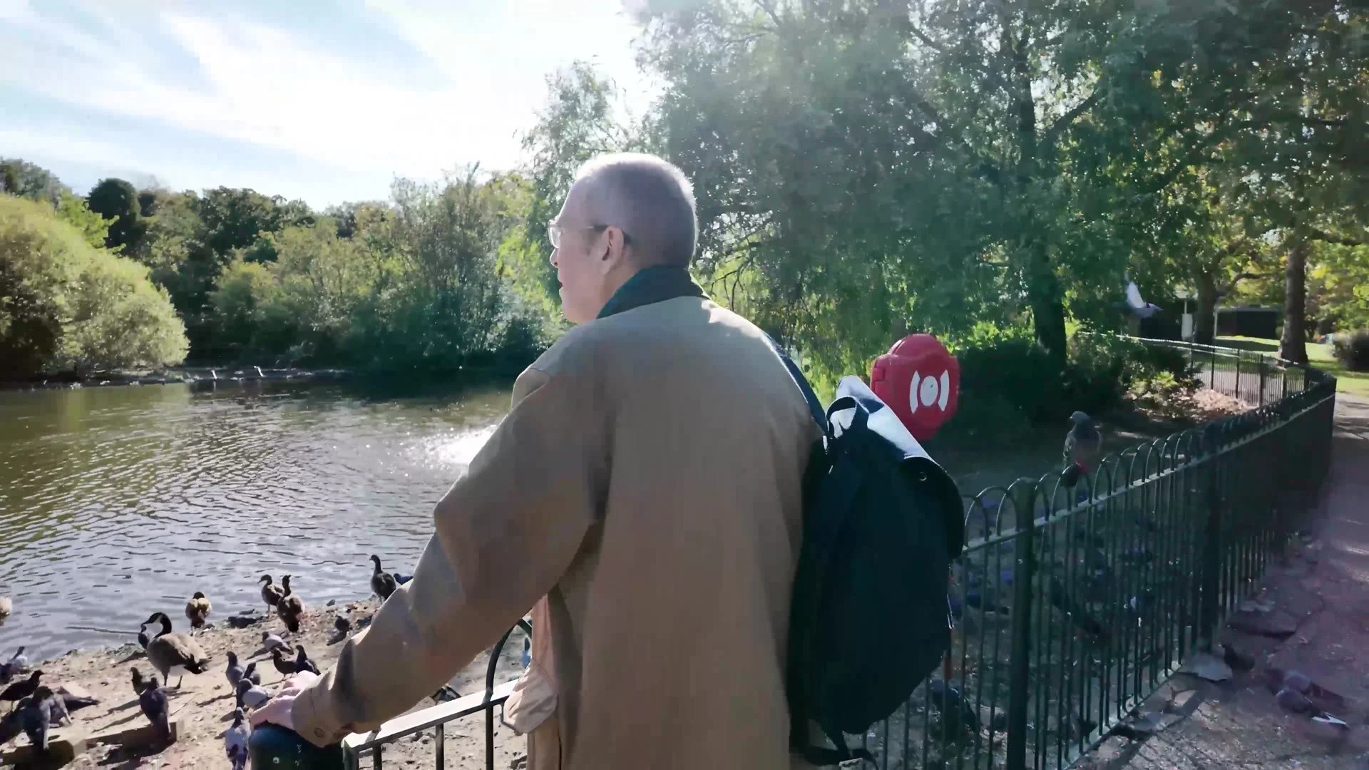 Michael feeding birds at the lakeside