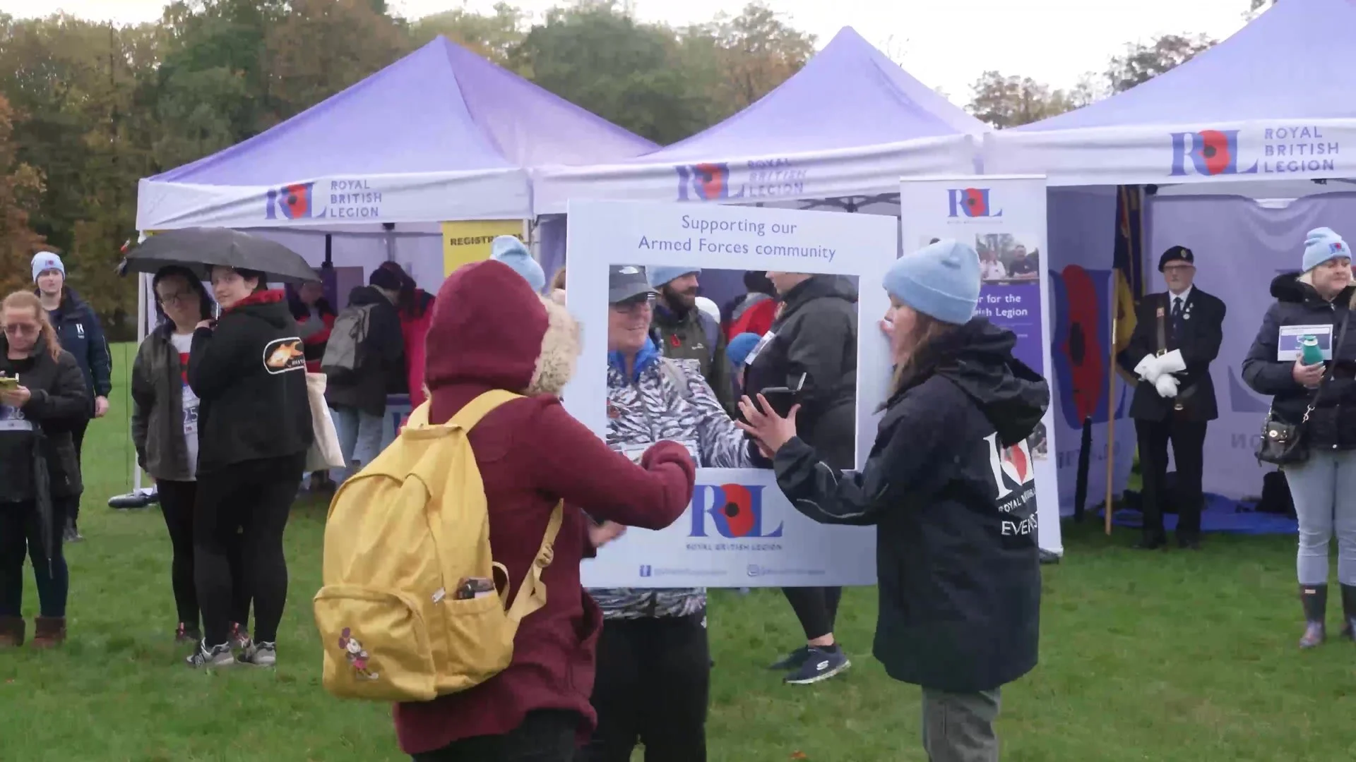 Walkers posing in a Royal British Legion selfie frame