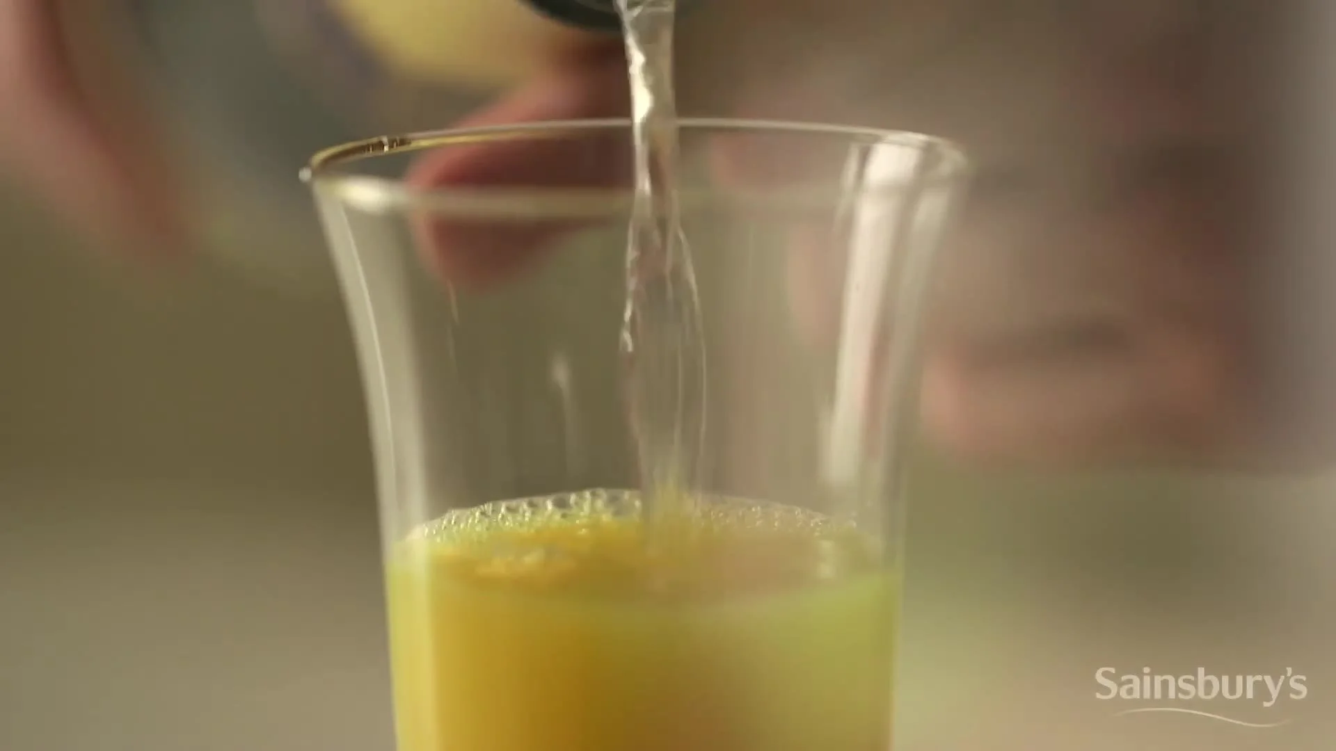Pouring orange juice for a Christmas breakfast cocktail