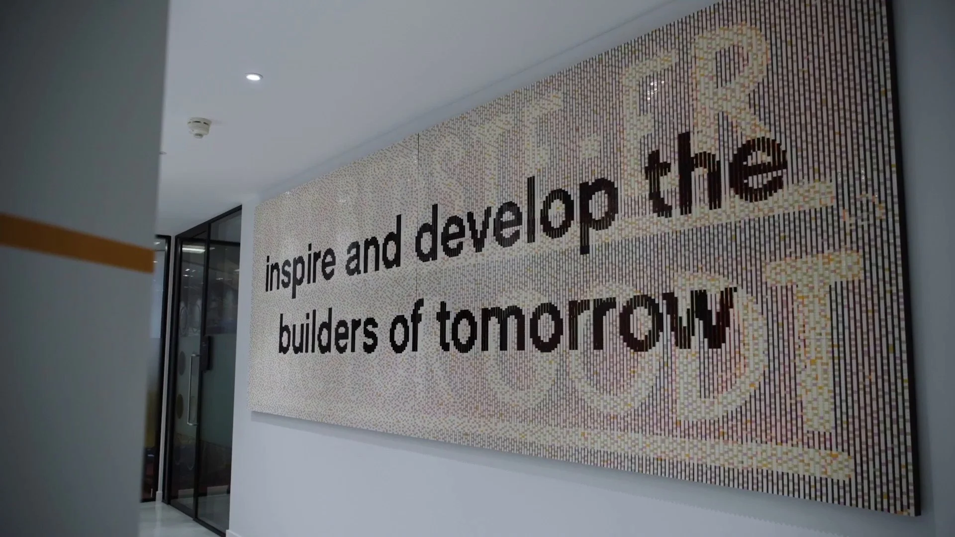 LEGO brick mosaic reading 'Inspire and develop the builders of tomorrow', filmed for the DLA Piper case study