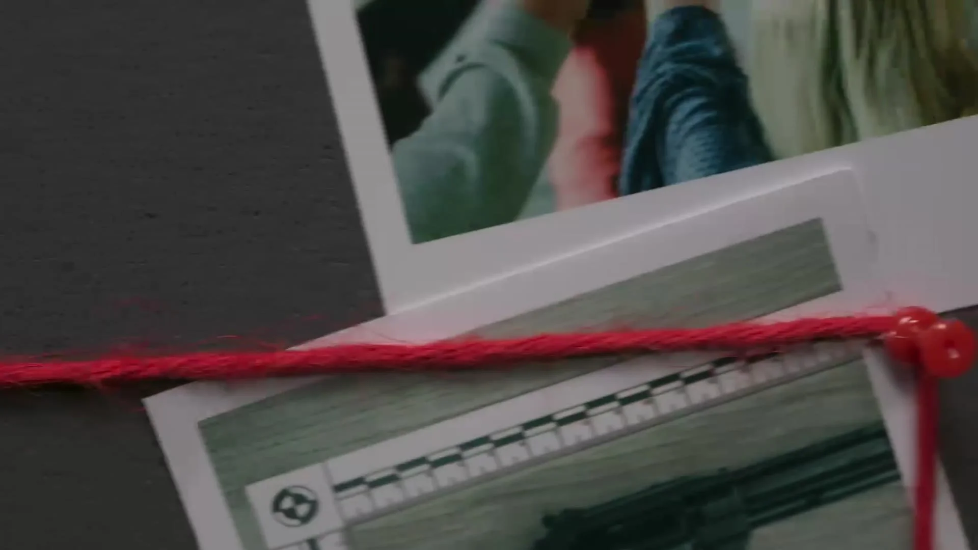 Evidence board with photographs linked by red string