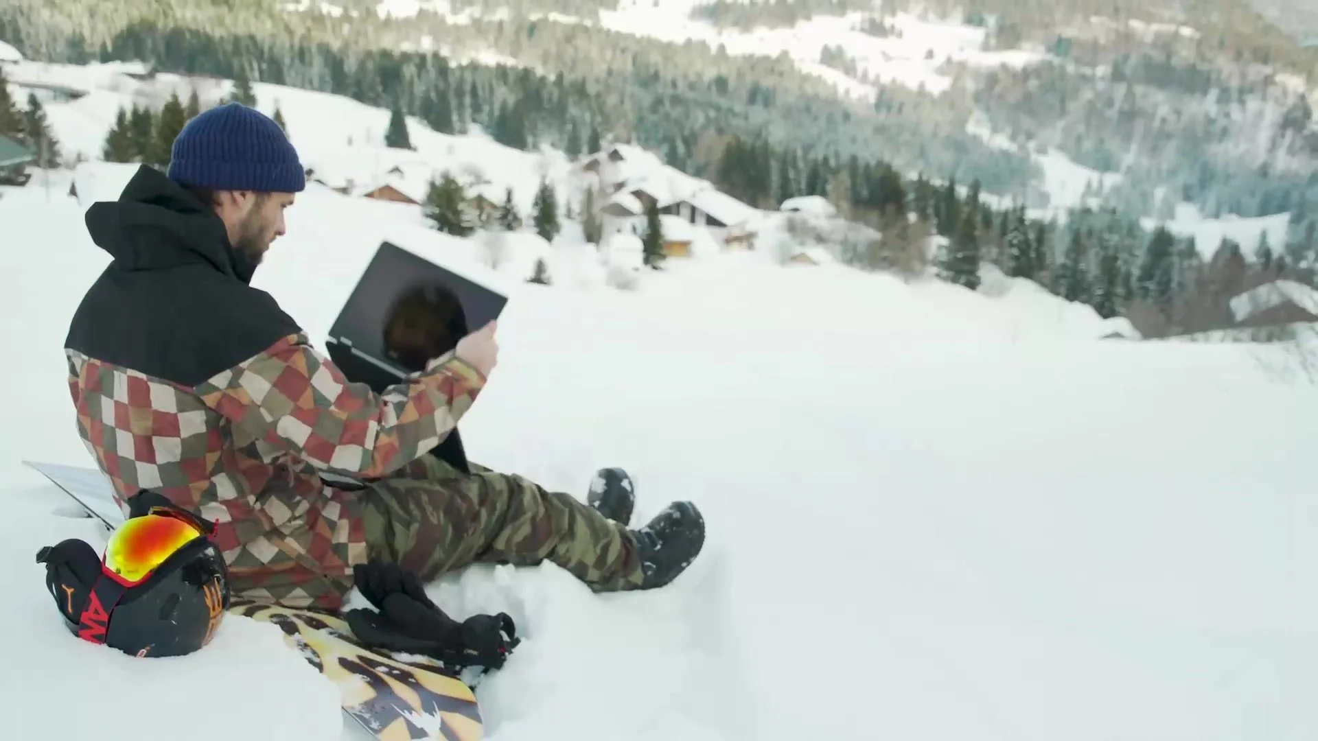 Snowboarder sitting in the snow using an Acer laptop, from the Acer influencer campaign