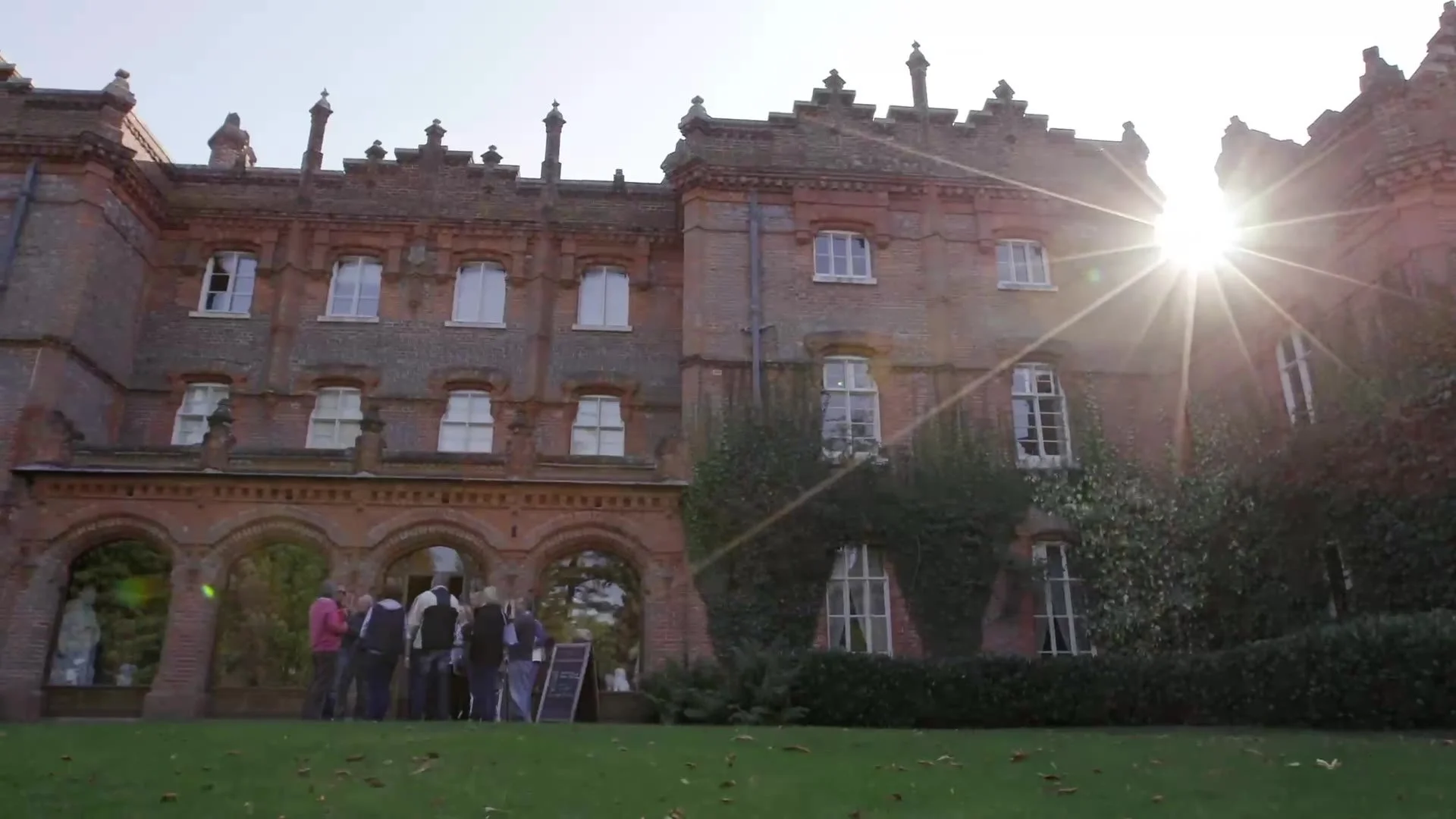 The front of a National Trust house at sunset