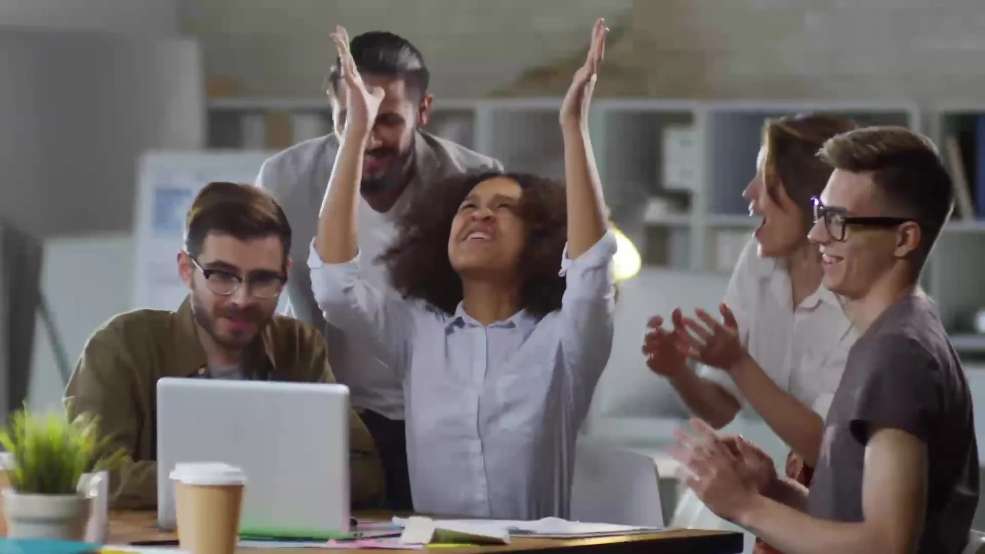 Team celebrating in an office, from a Railsbank advert