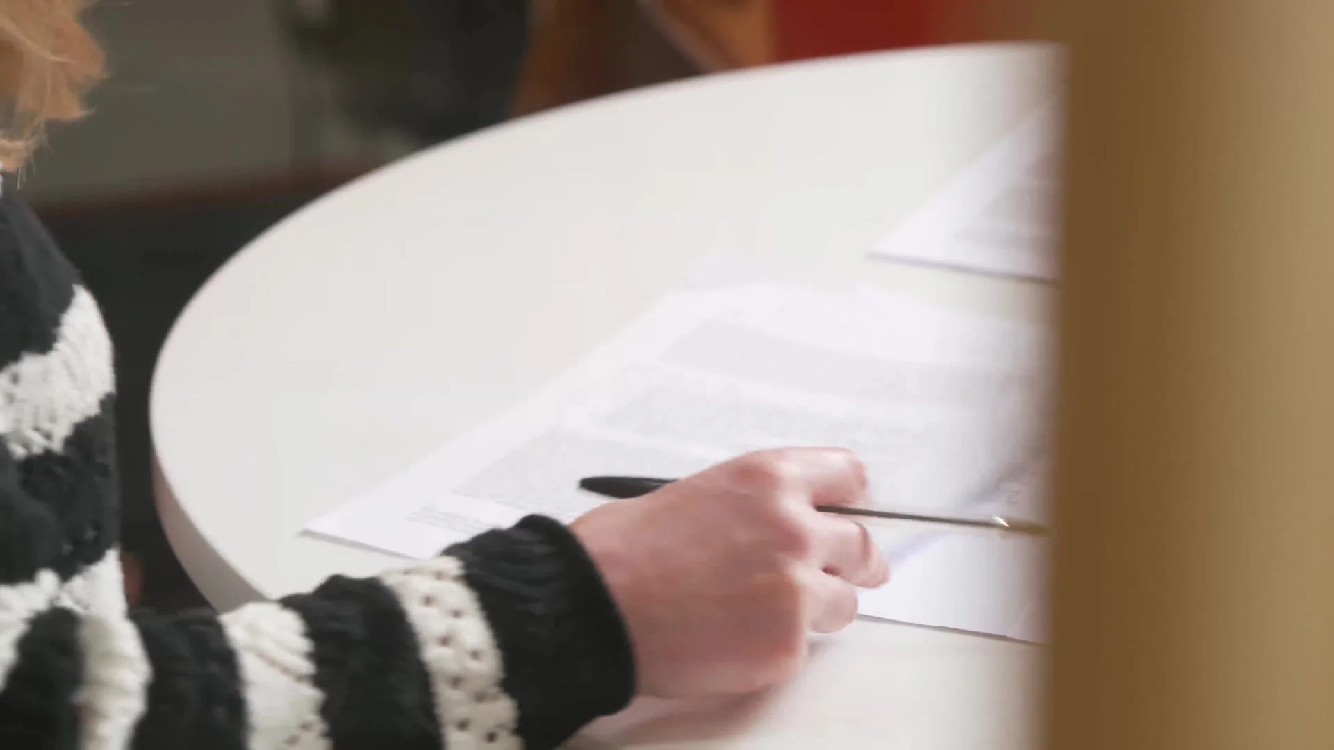 A student making notes on a draft