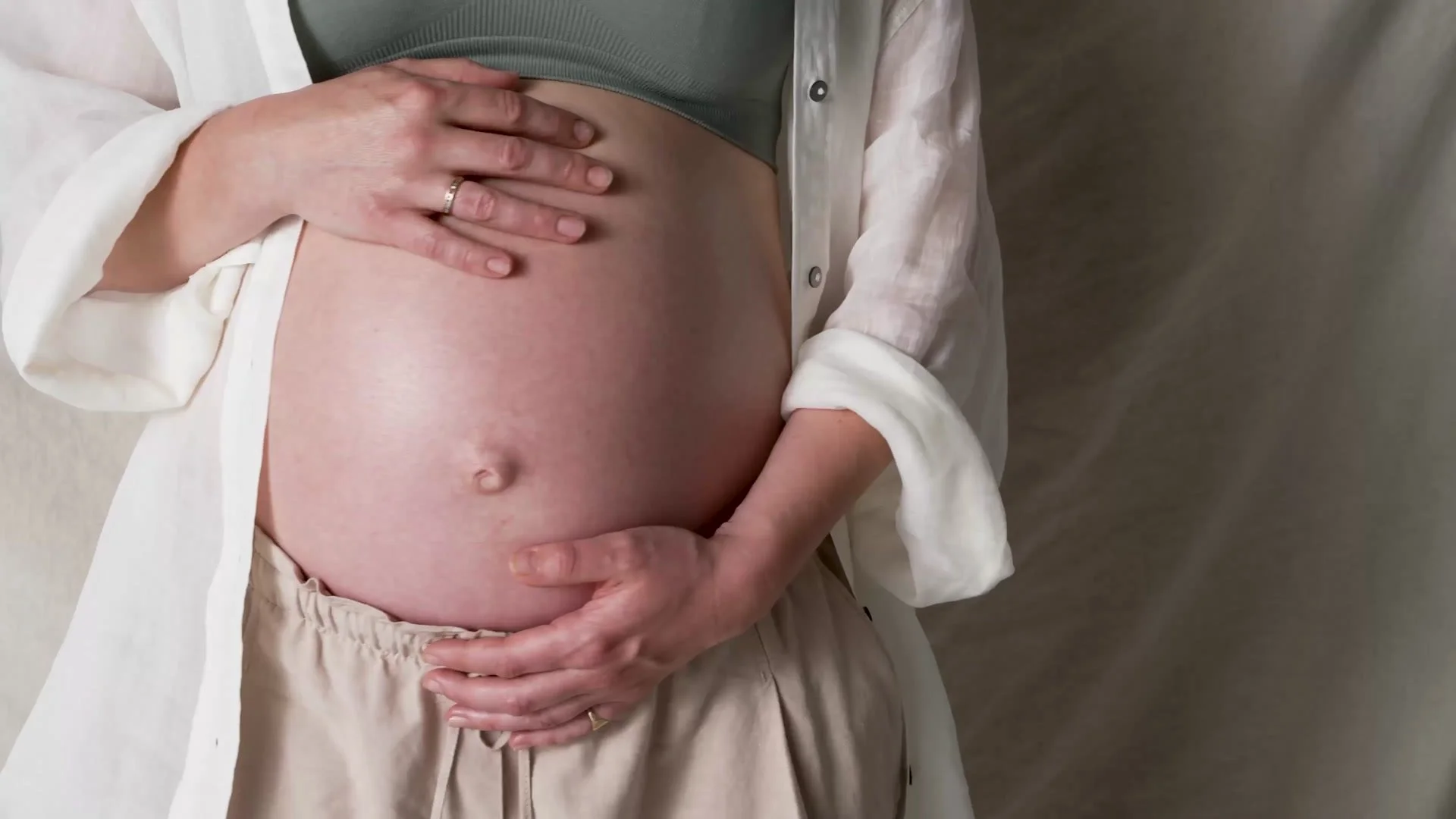 Expectant mother holding her bump, from the Mothercare Bump to Baby film