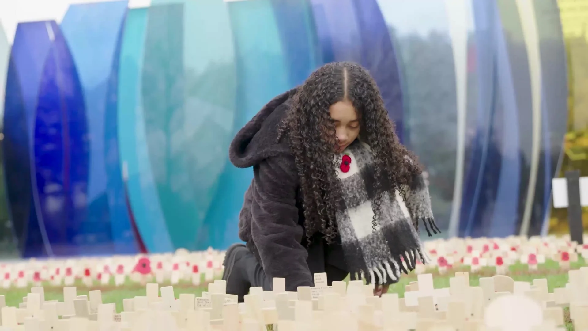 A young visitor placing a tribute