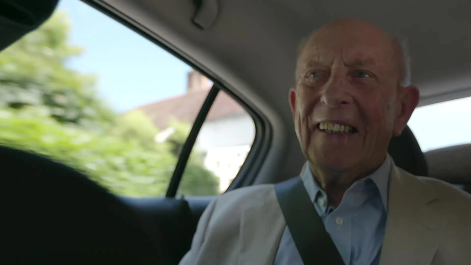 Older man enjoying the view from the car on the drive