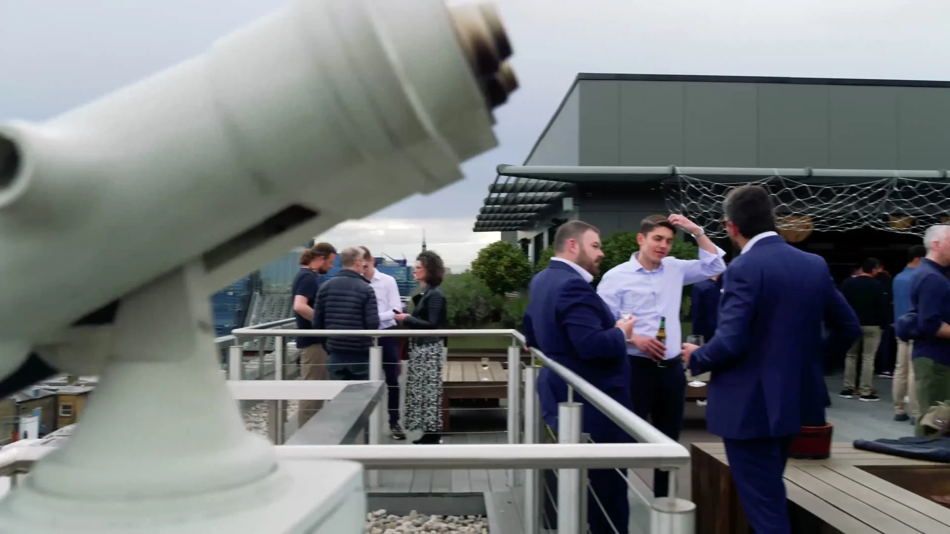 Guests networking on the rooftop