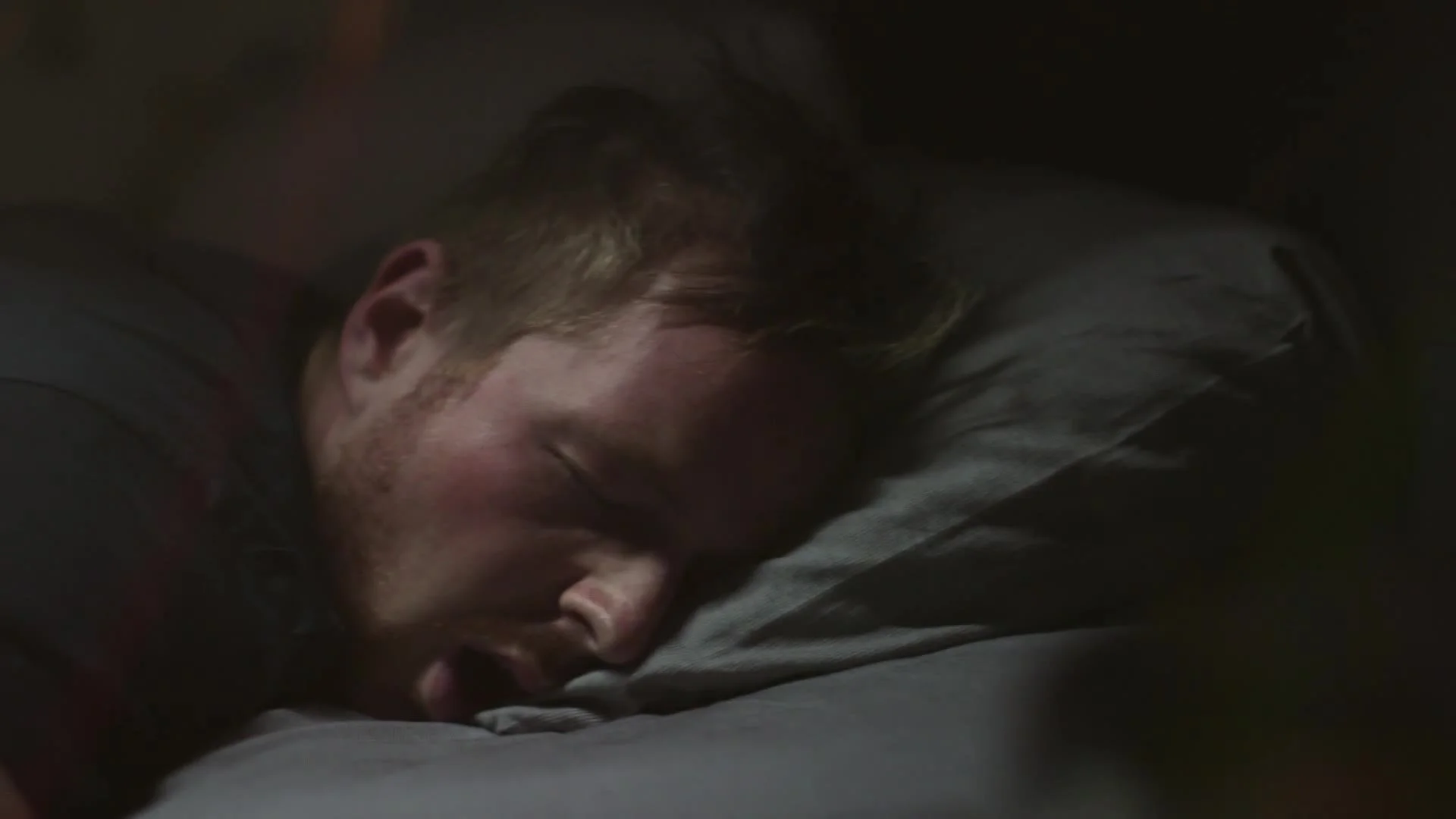 Man asleep in bed, from the MaxiNutrition Lie-In ad