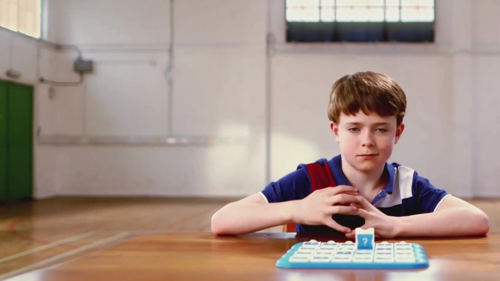 Boy at a desk in a sports hall, from the Octopus Energy TV advert