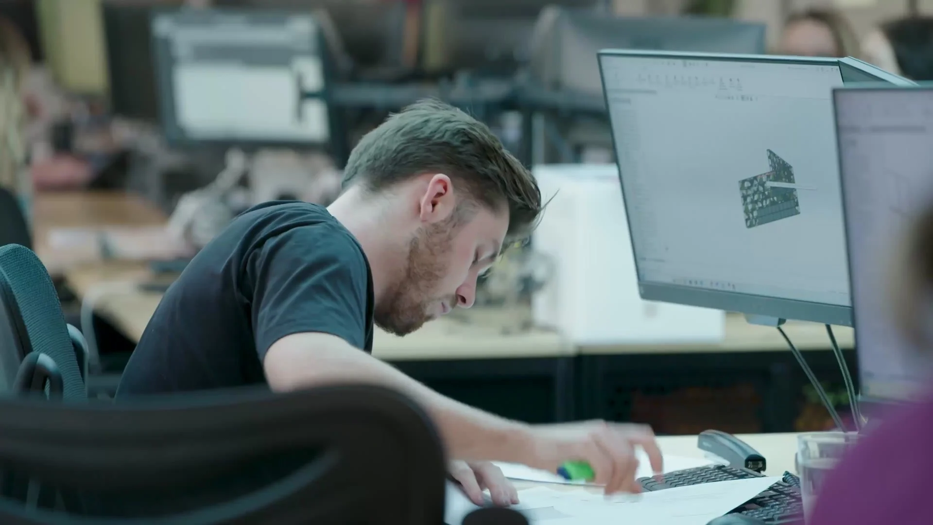 Unibox designer working on a 3D model at his desk