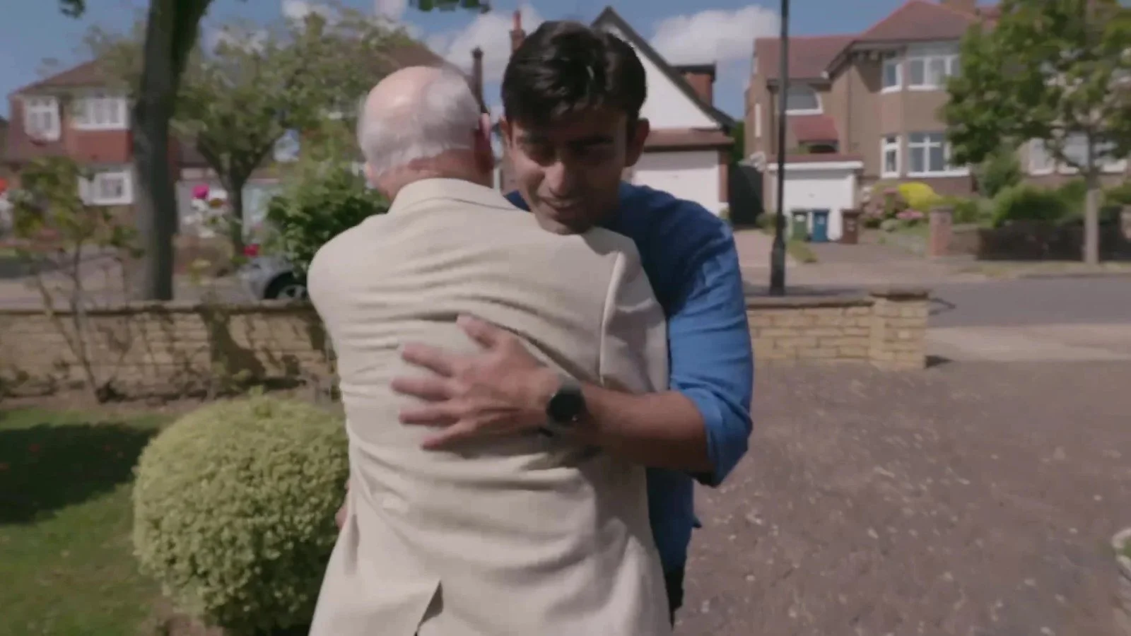 Older man greeting his volunteer driver with a hug, from the Esso #journeysthatmatter film