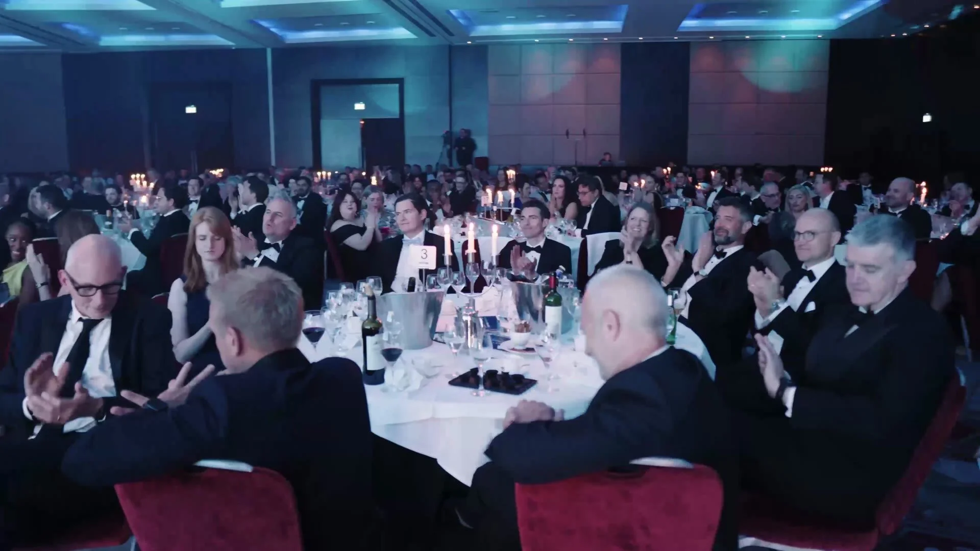 Guests applauding at their tables