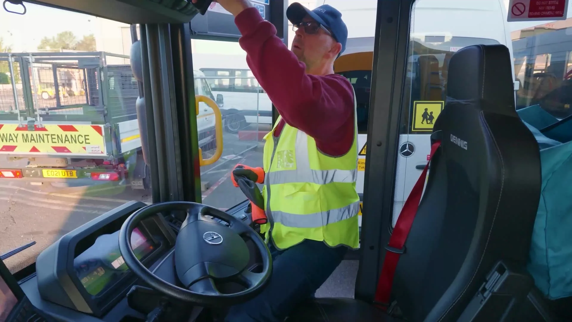 Refuse vehicle driver climbing into the cab