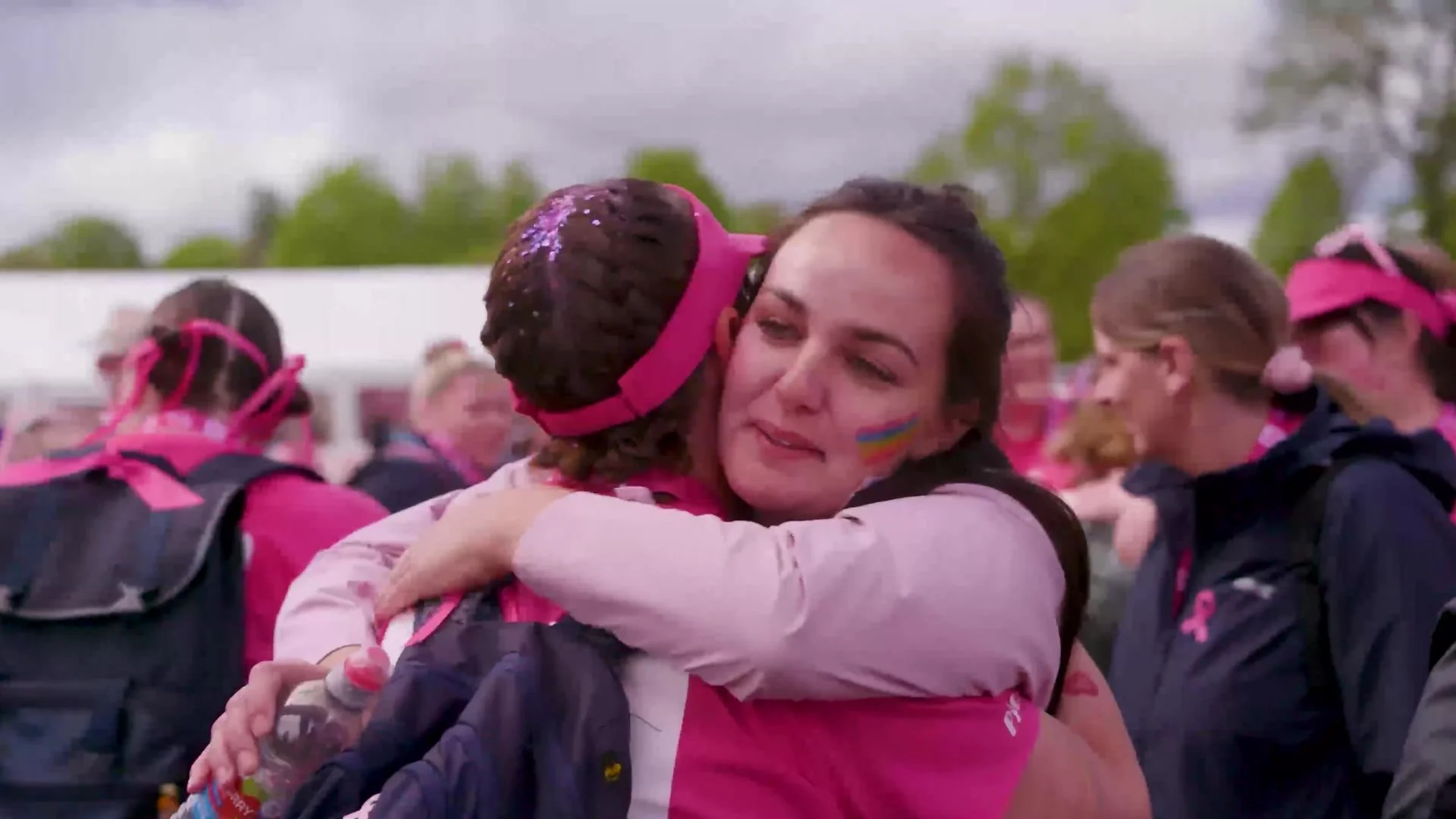 Walkers hugging at the finish of the Pink Ribbon Walk