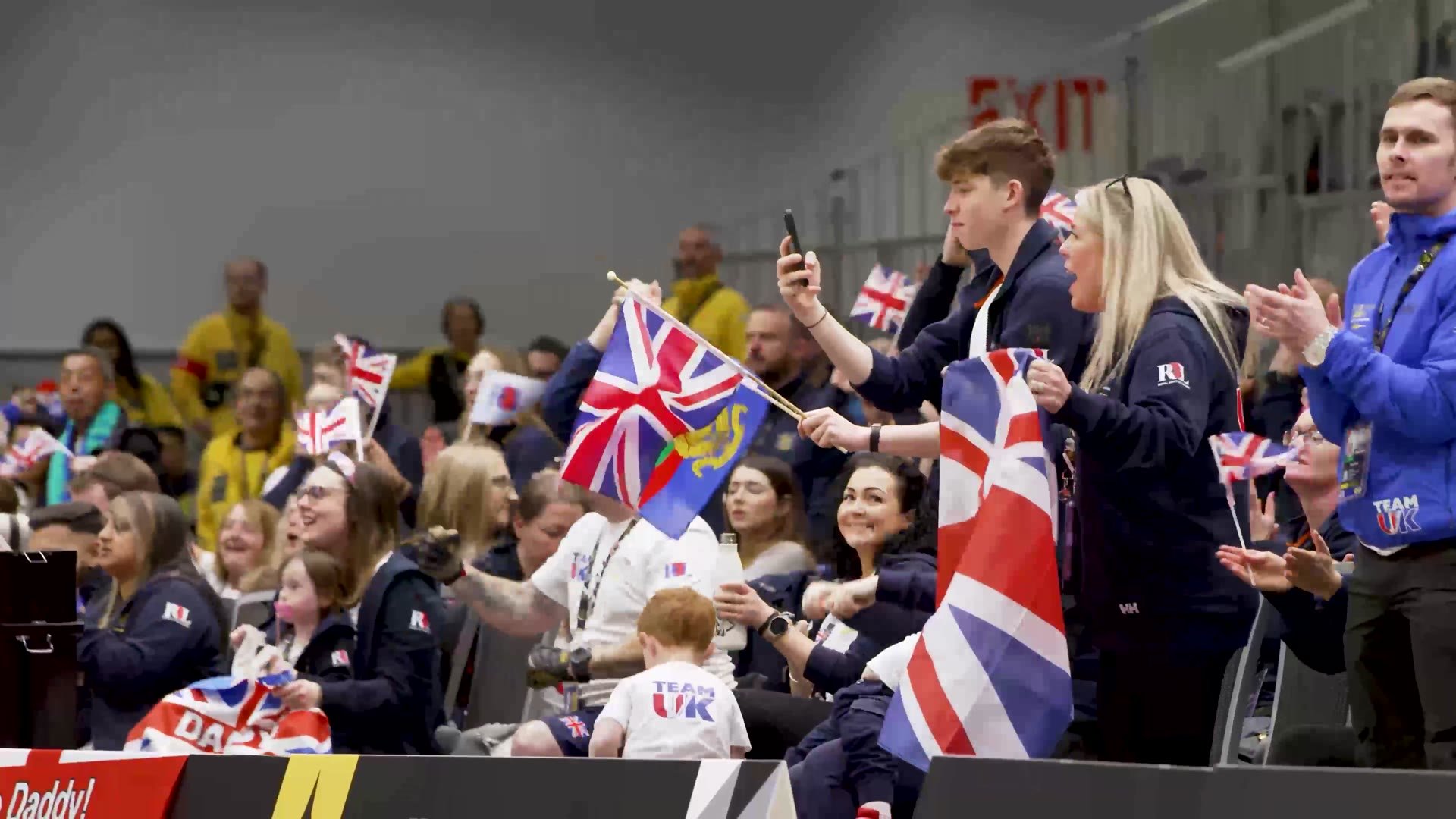 Team UK supporters waving Union flags in the stands at the Invictus Games