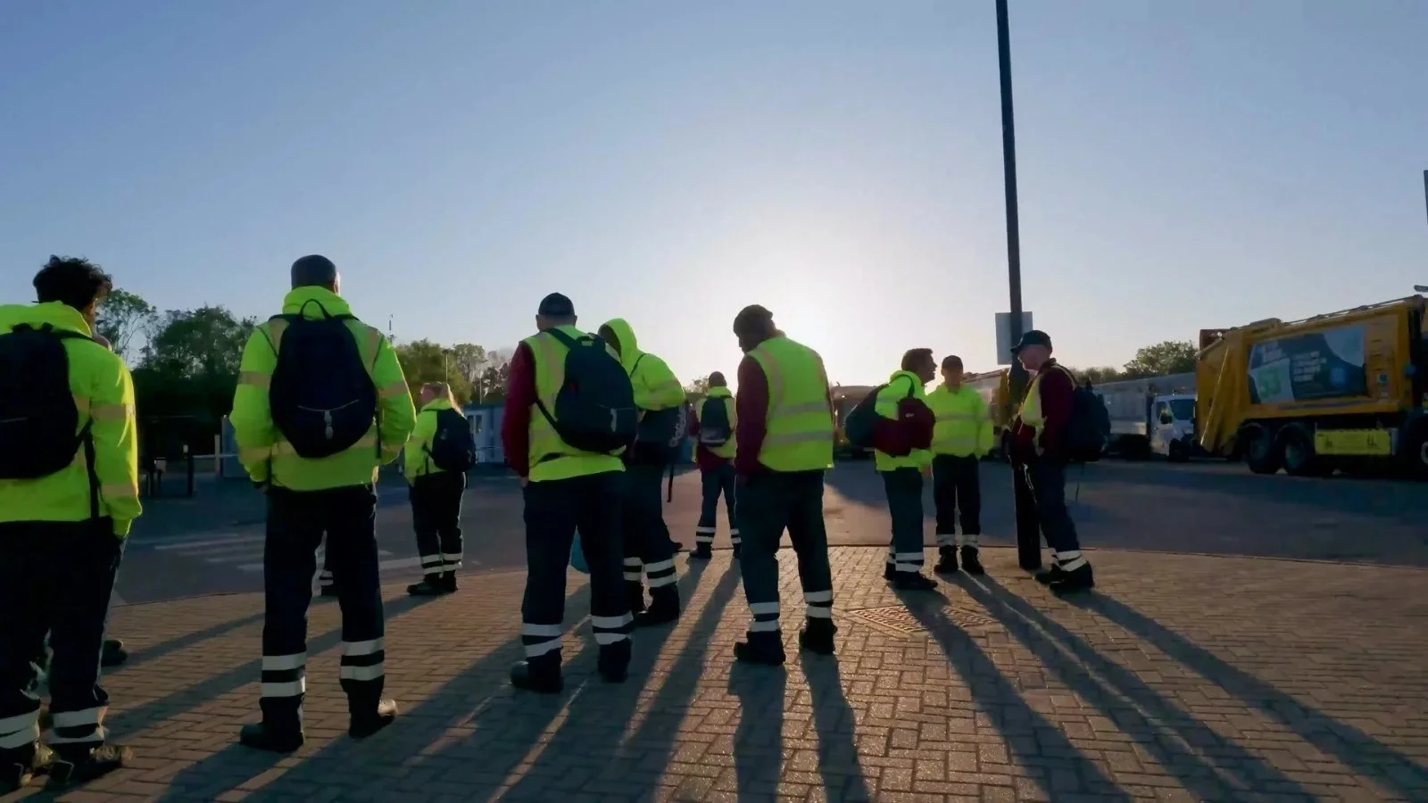 Waste crews heading out to their vehicles at dawn