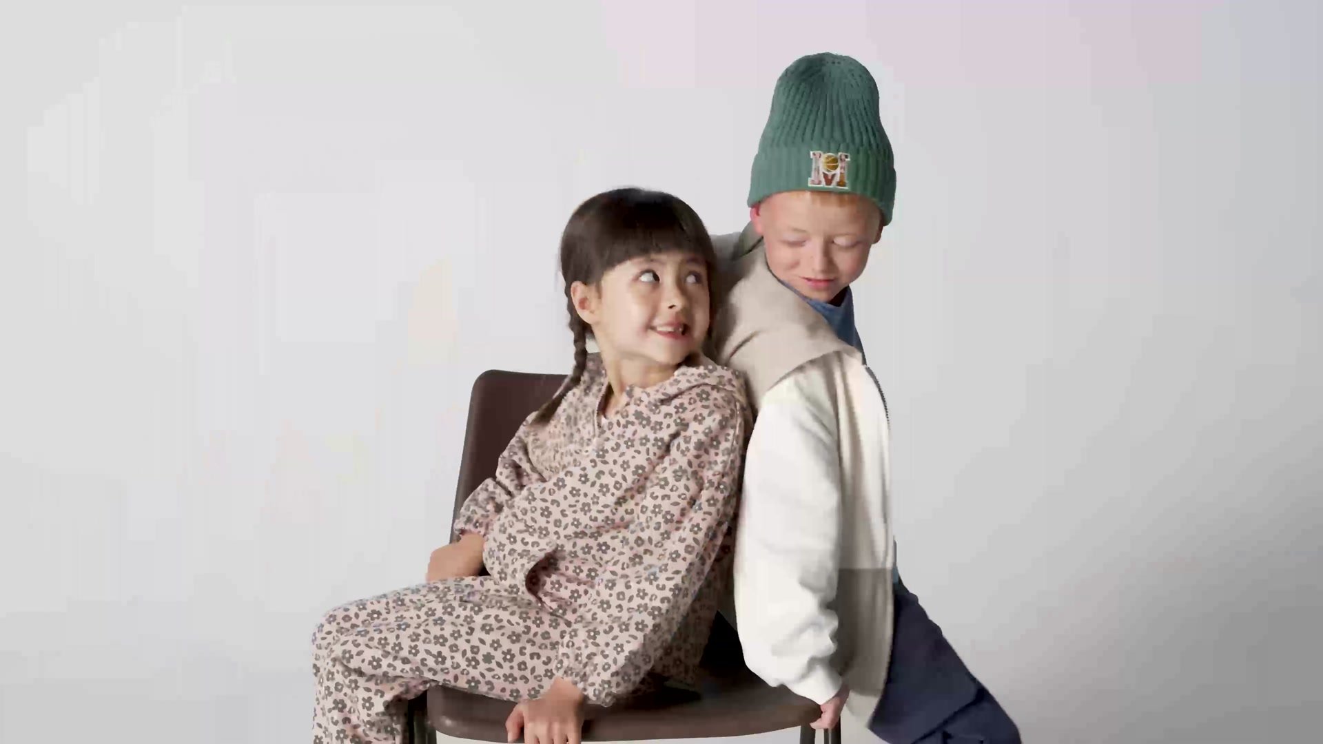 Two children in kidswear sitting together on set, from a Mothercare shoot