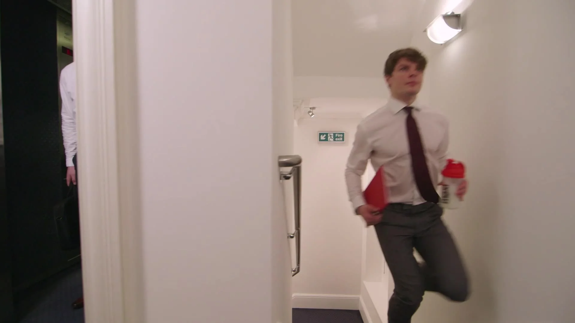 Office worker sprinting down a corridor, from the MaxiNutrition Lift ad