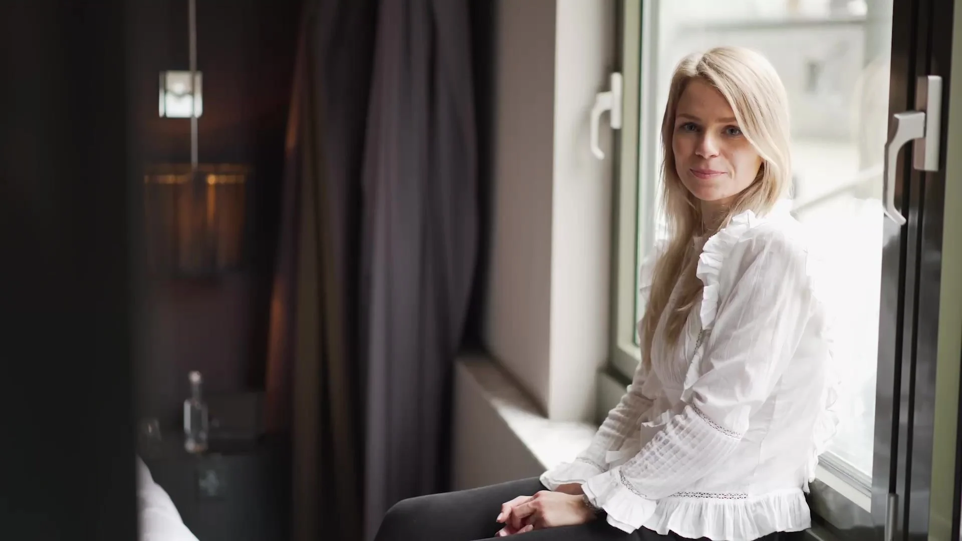 Blogger sitting by a window for the Acer influencer film