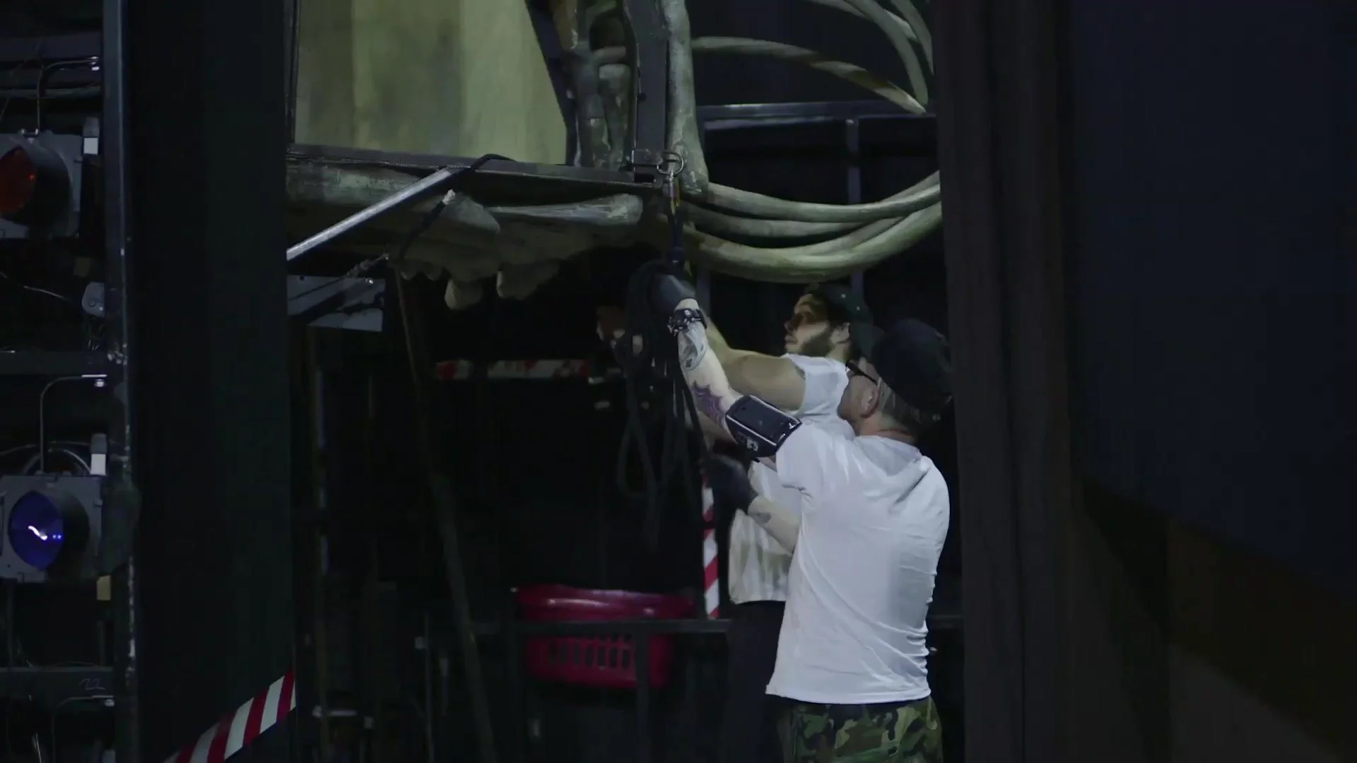 Stage crew checking rigging backstage before a performance of The Lion King