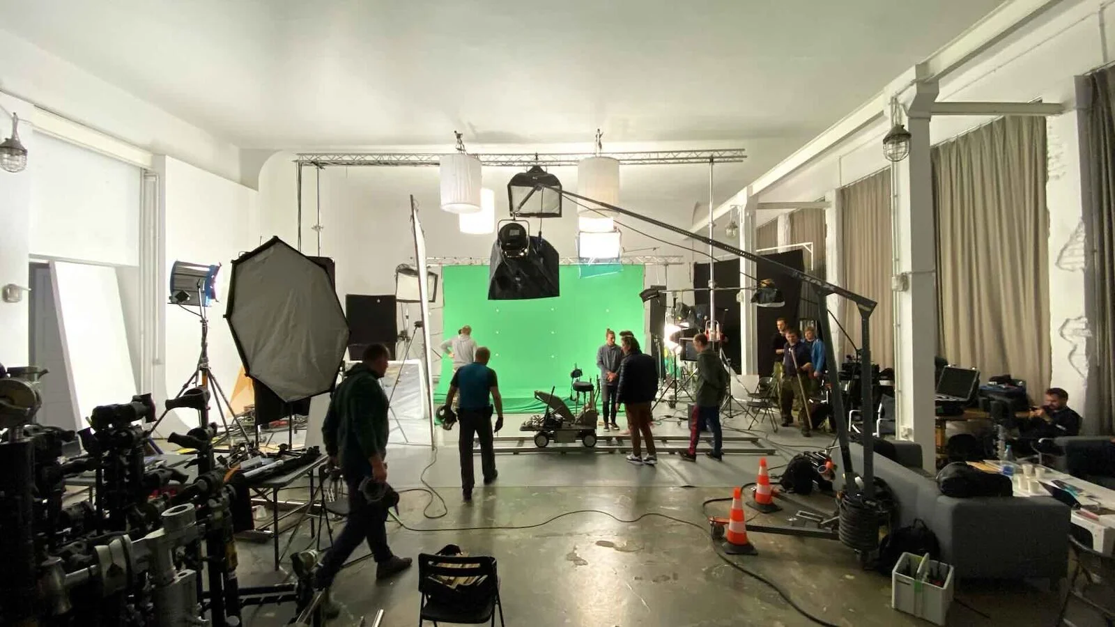 A green-screen studio set up with lights and camera
