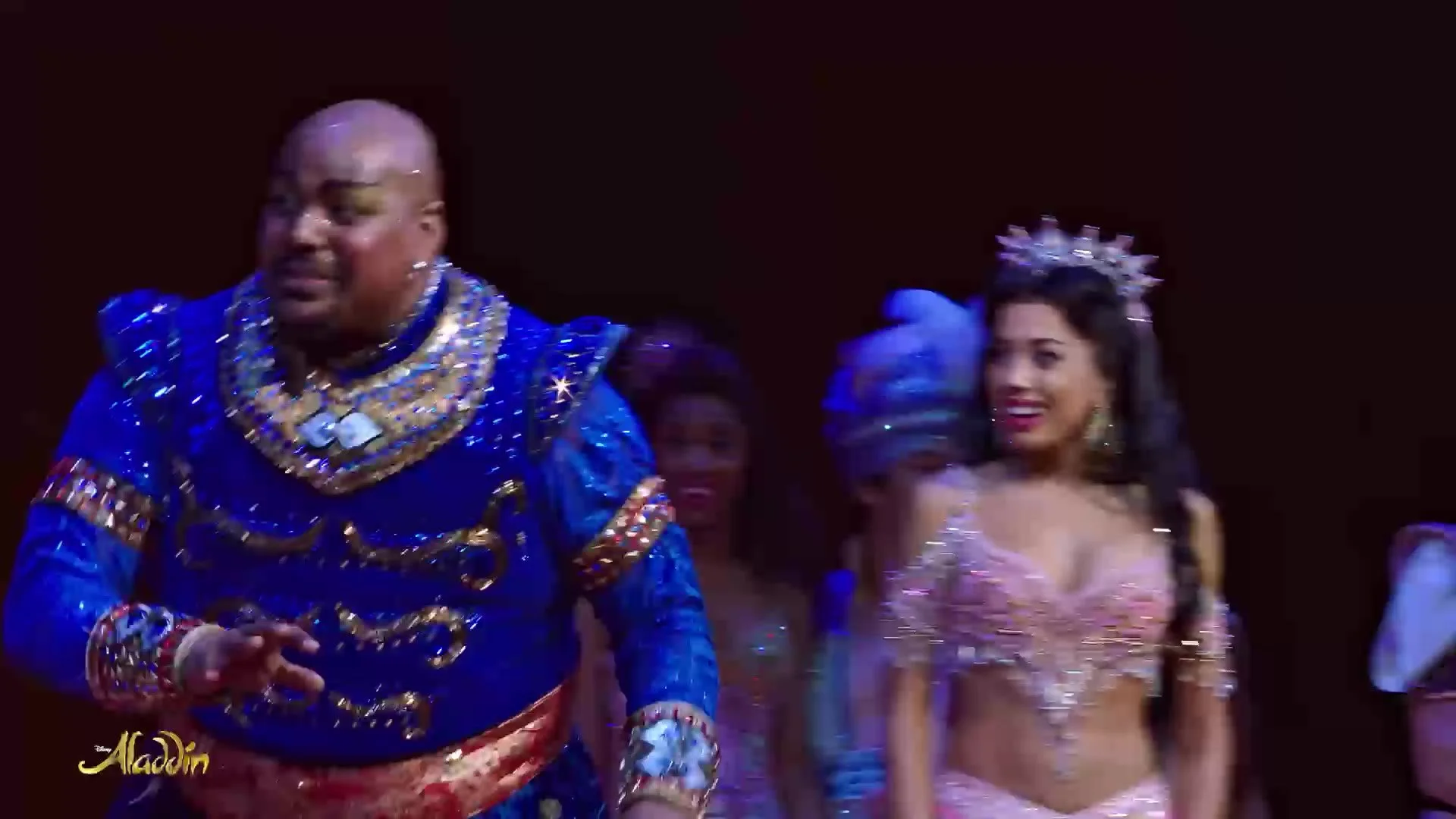 The Genie with Jasmine and the company on stage