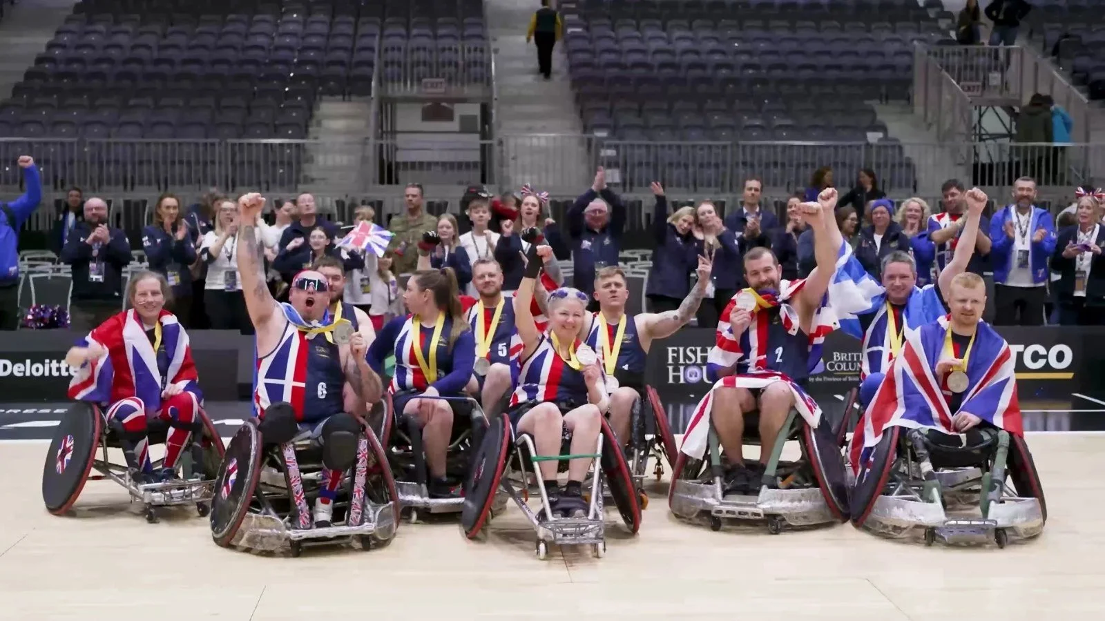 Team UK wheelchair rugby squad celebrating with Union flags at the Invictus Games