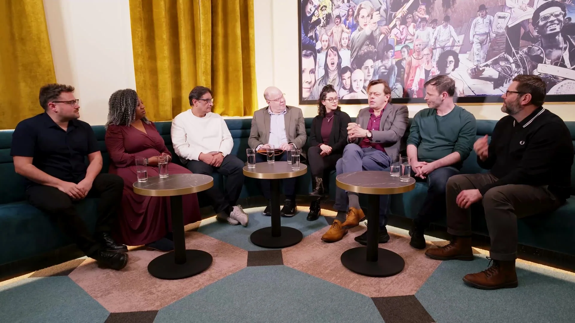 Seven writers and the host around the table