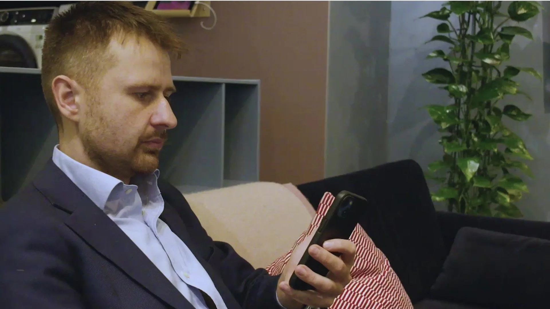 Mateusz Jazdzewski of Electrolux checking his phone in the office