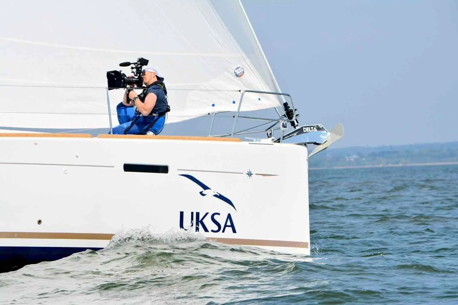 A Sneak camera operator filming from the bow of a UKSA yacht