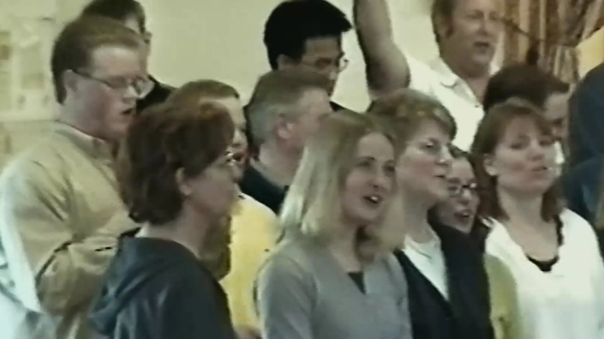 Congregation singing in archive footage from the trailer