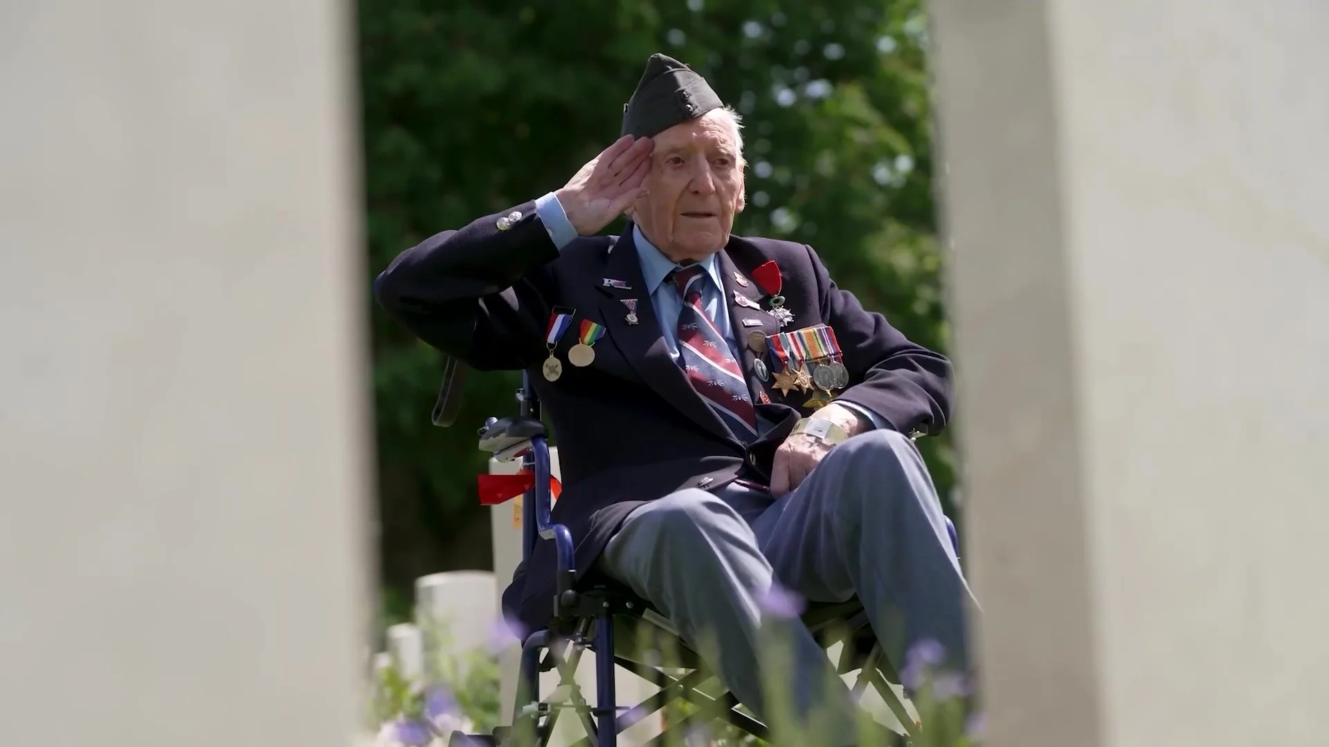 Veteran in uniform and medals saluting at a remembrance event