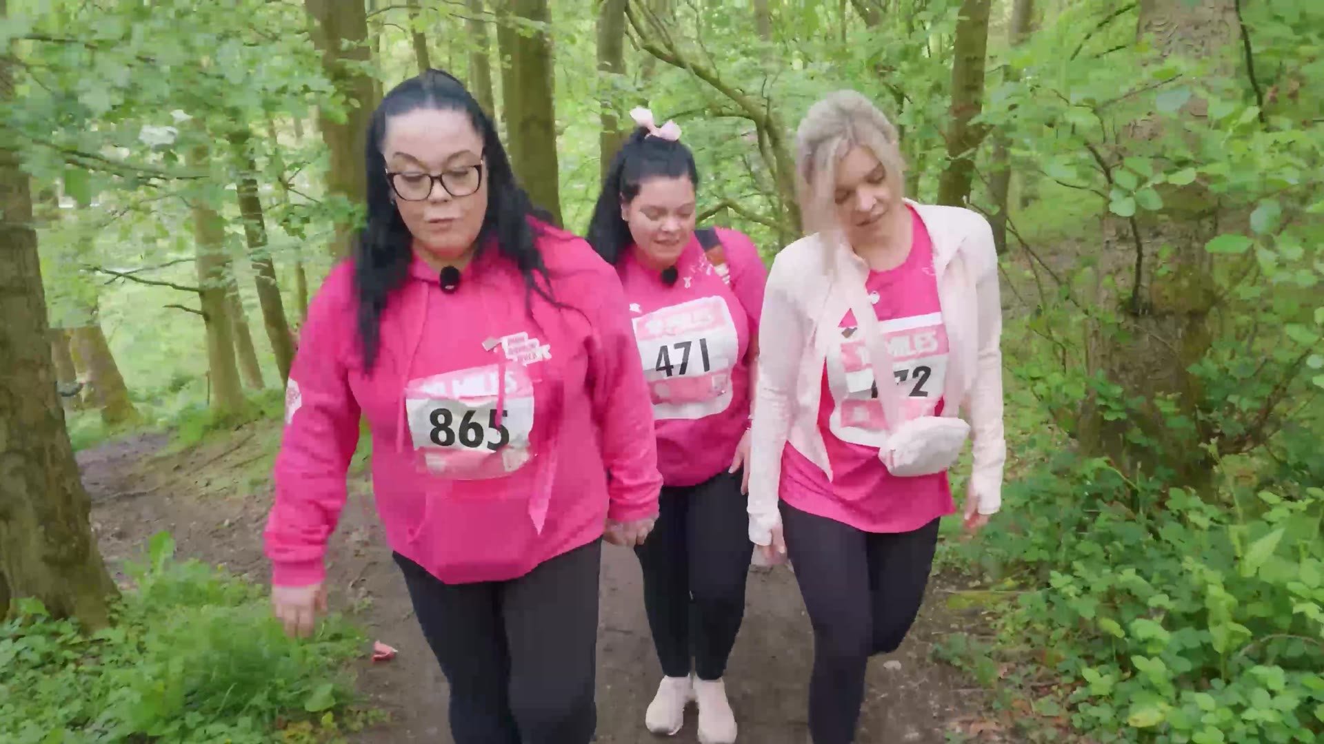 Lisa Riley walking through the woods with fellow walkers