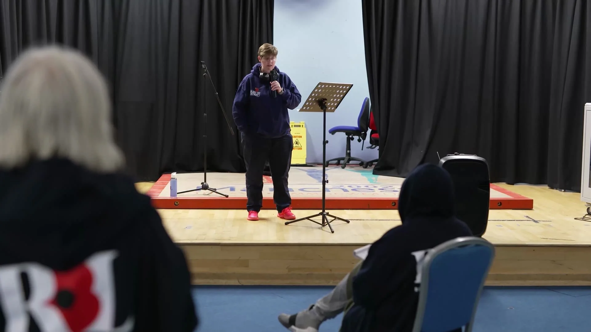 A participant rehearsing a set on stage