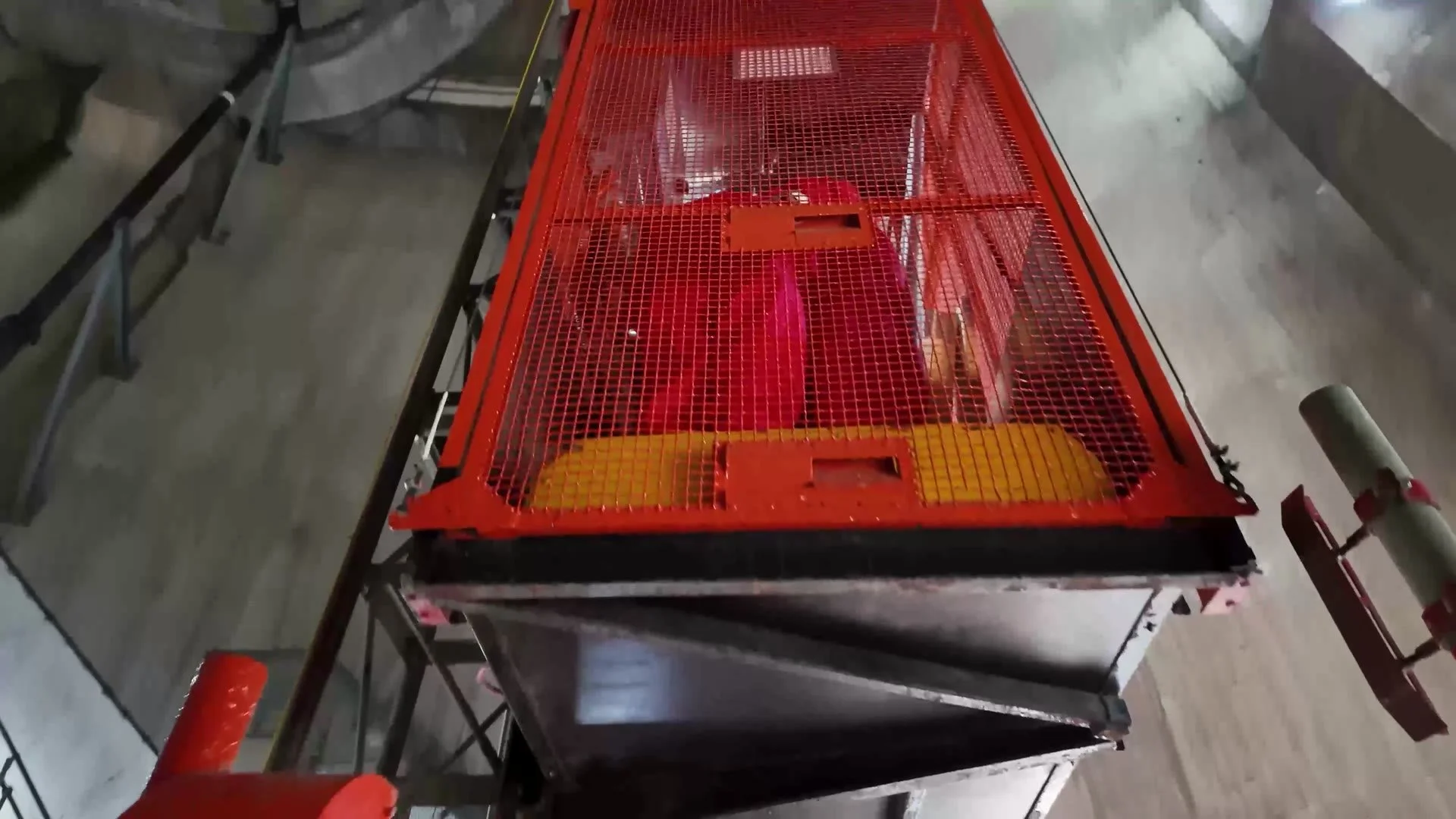 Custom-built hoist cage used to move workers and materials inside the chimney