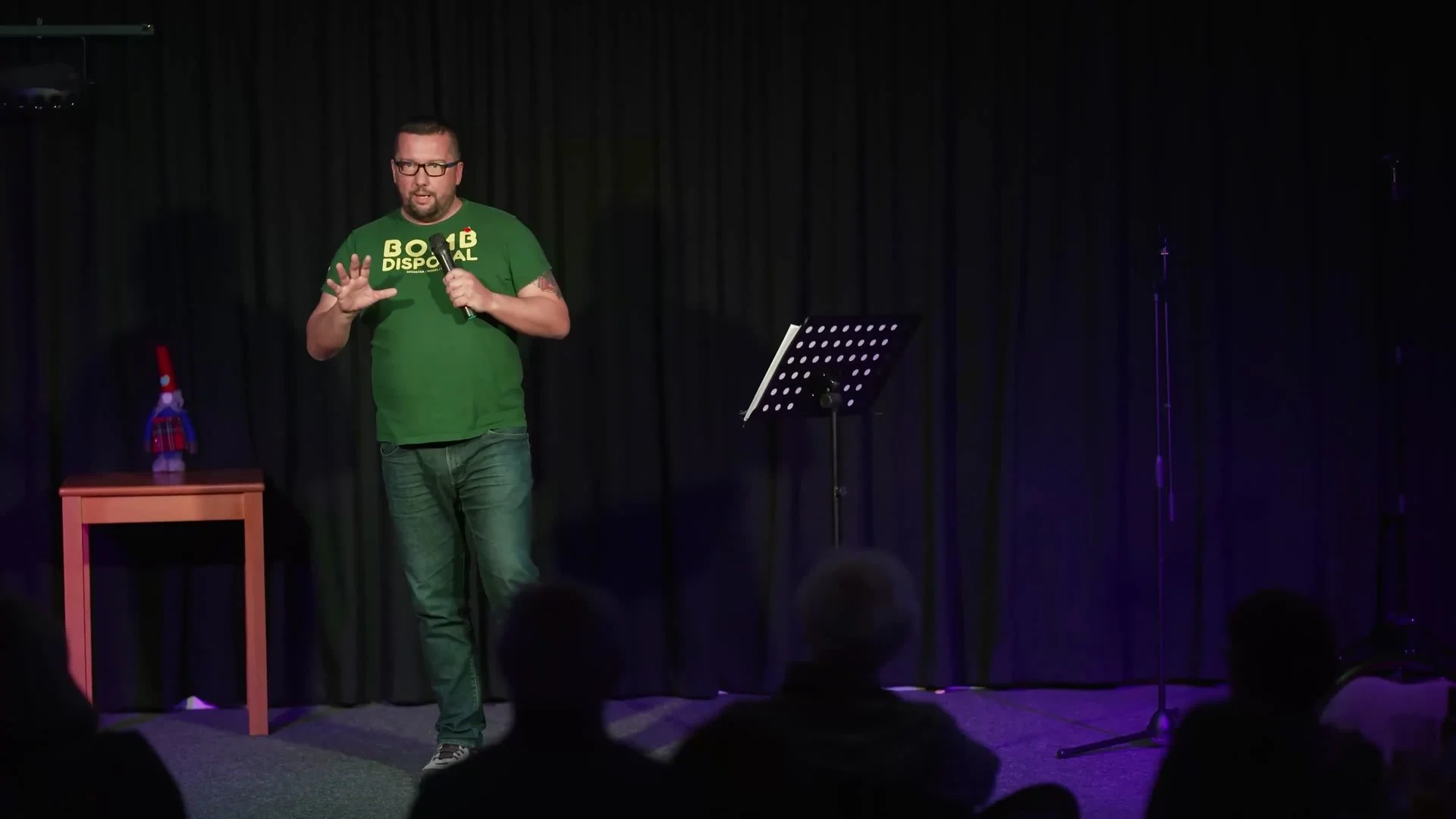 A participant performing stand-up to a live audience