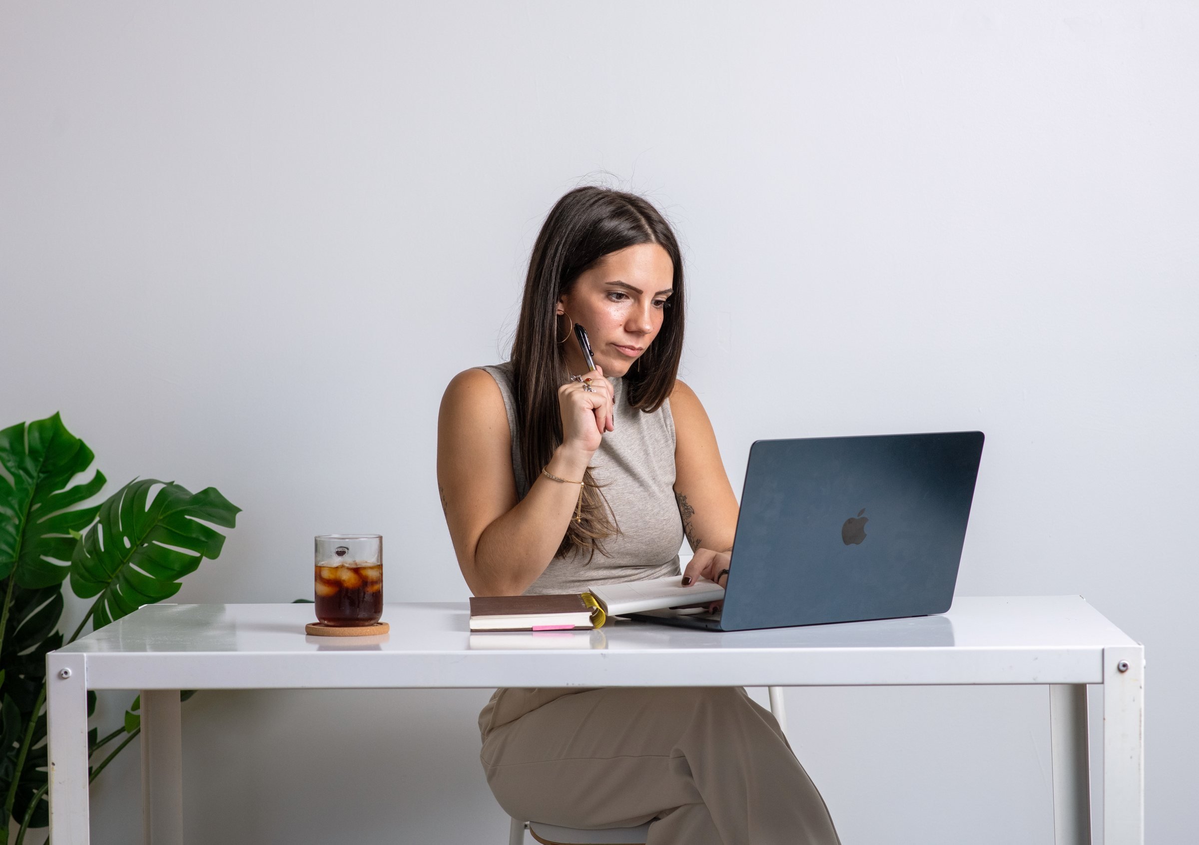 Sky at her desk with a laptop and notebook