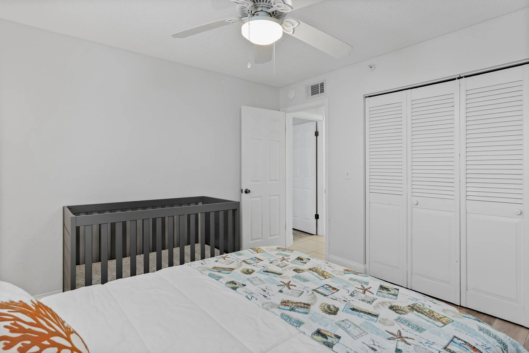 Primary bedroom, king bed and crib. Lower level.