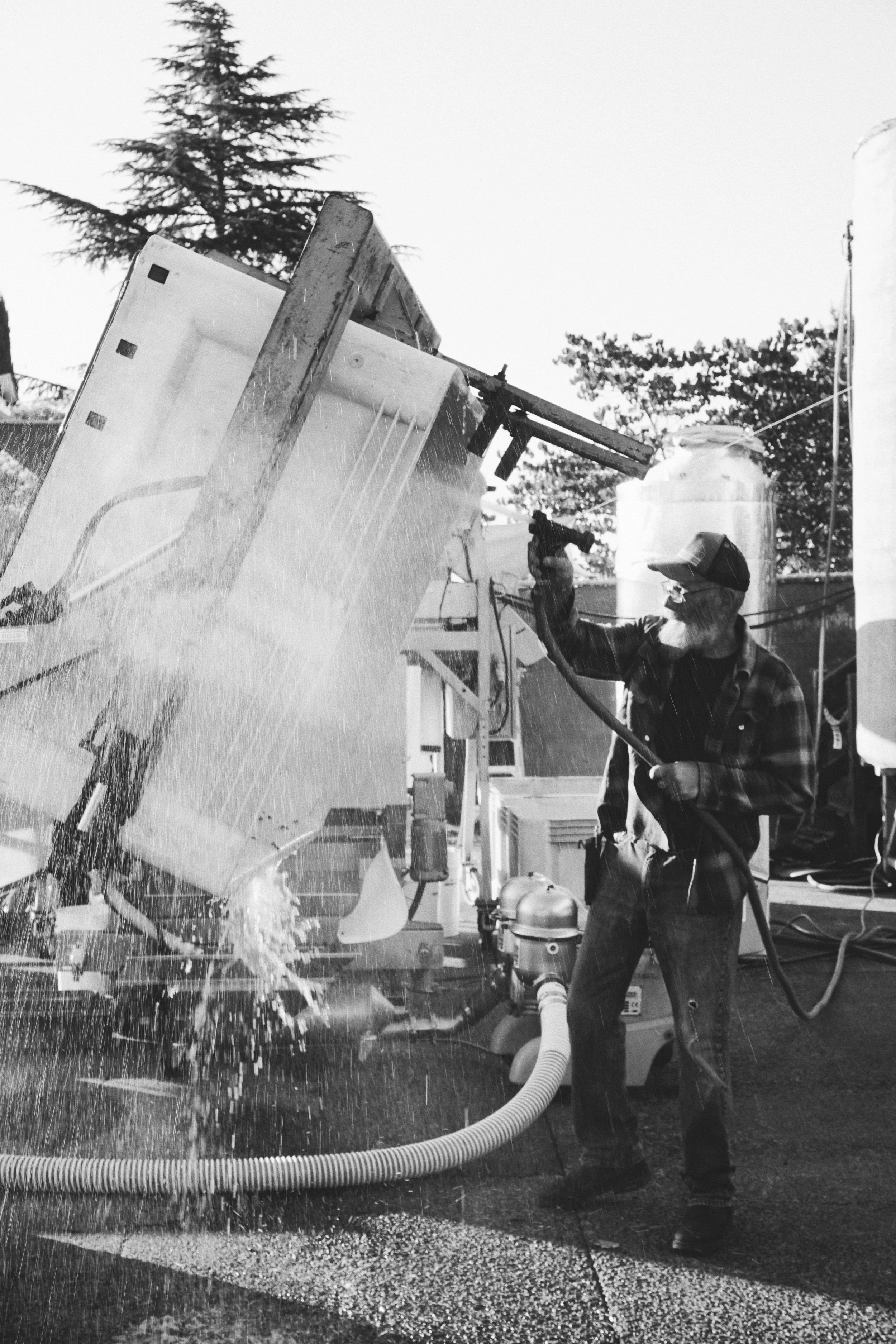 Winery crew cleaning equipment during harvest season in Napa Valley.